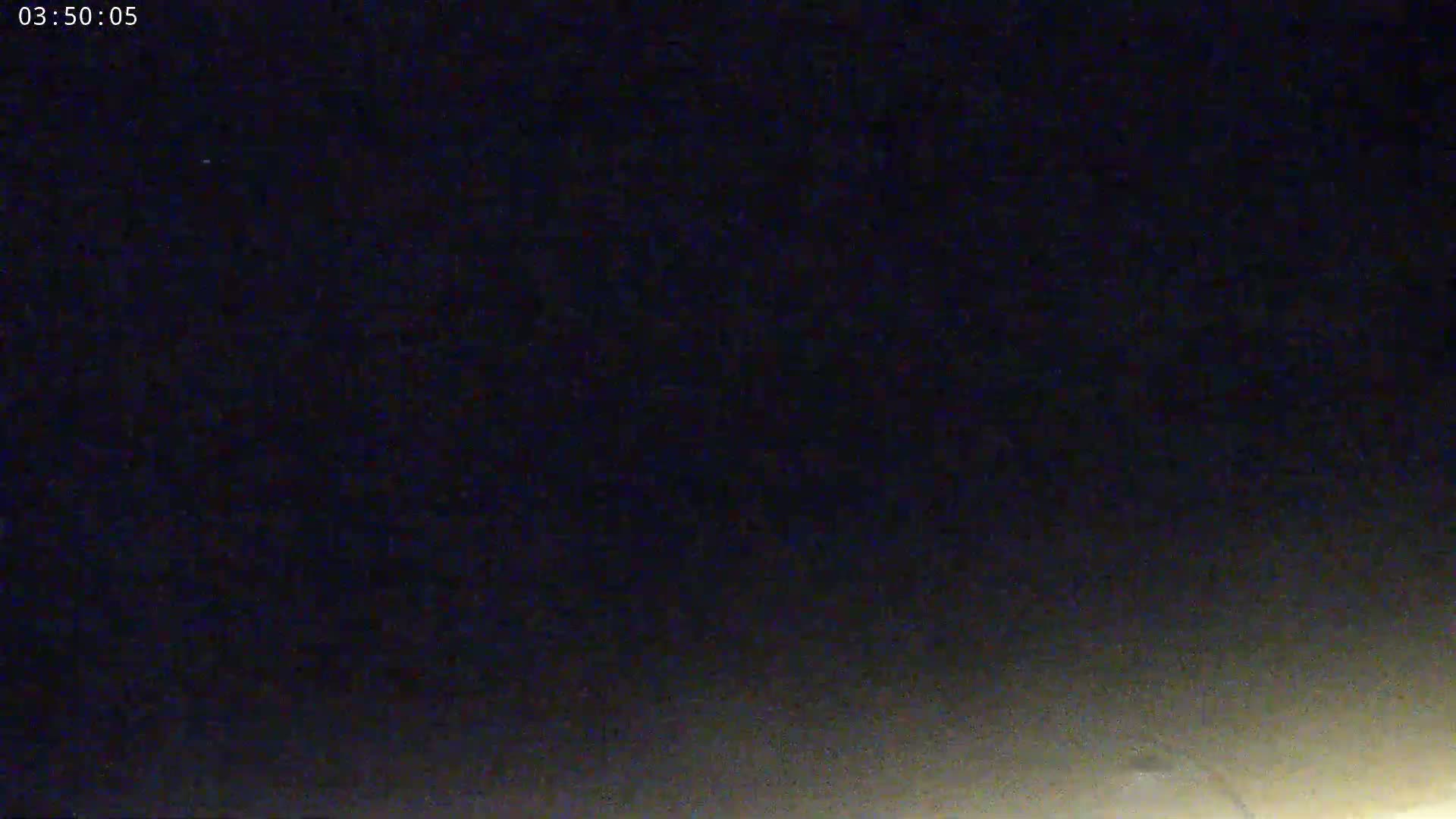 A nighttime image shows a dark sky gradually brightening near the bottom.
