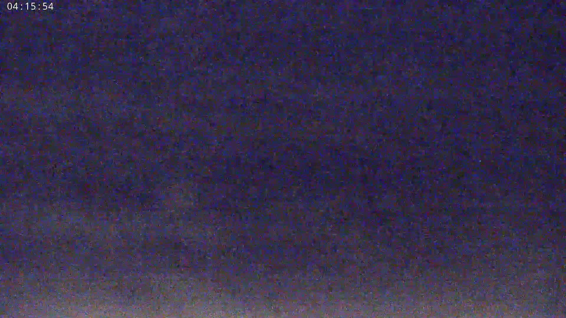 A dark, blurry image shows a night sky with a gradient of dark purple and slightly lighter shades near the bottom.