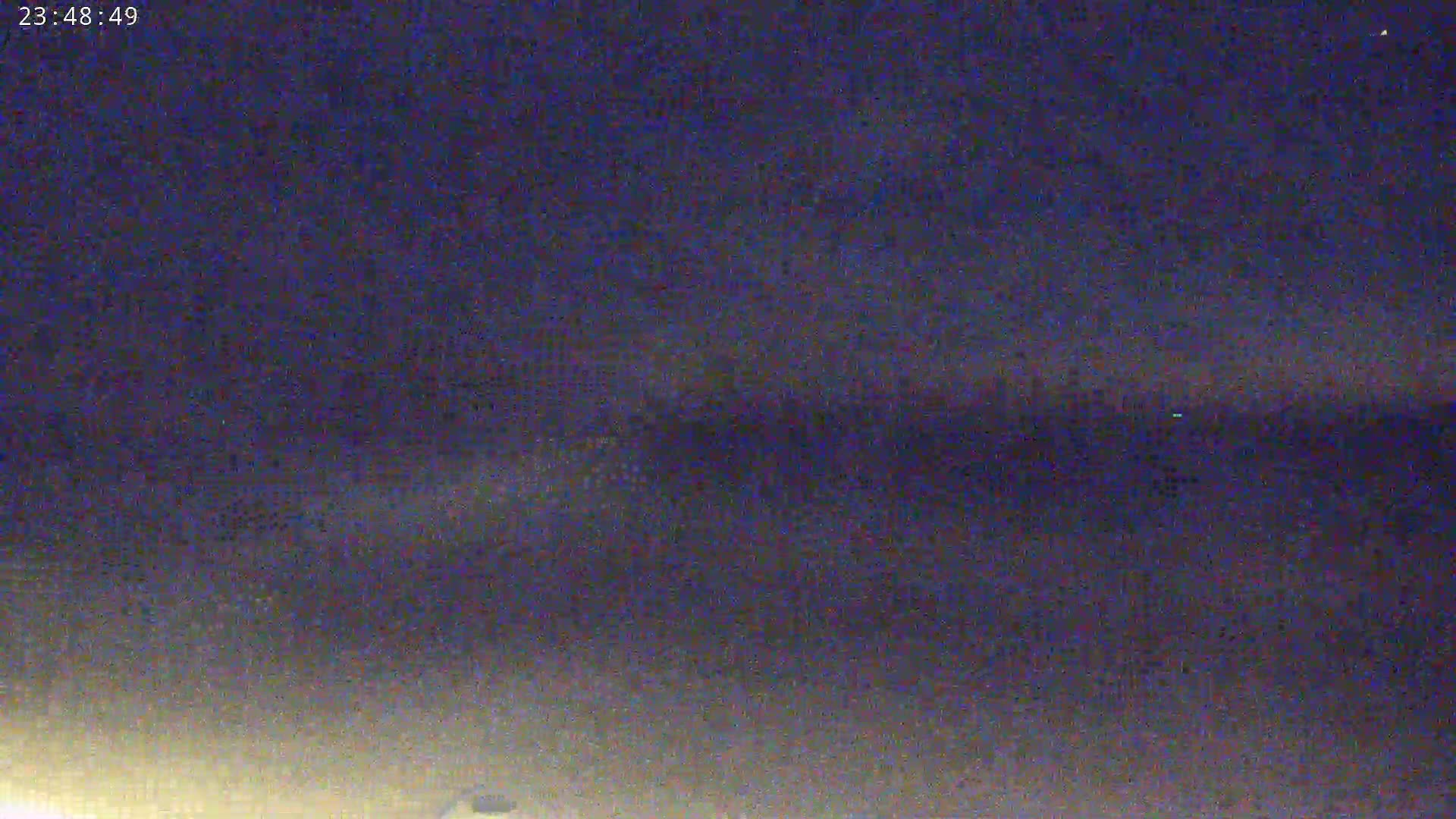A nighttime, dark sky with faint clouds is visible.