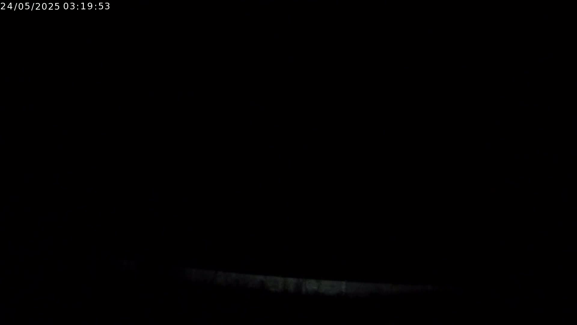 A very dark image shows a faint, horizontal line at the bottom, suggesting it's nighttime.
