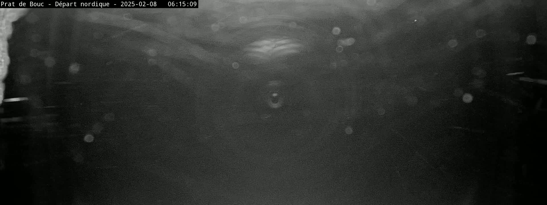 A dark, blurry image shows a tunnel-like space with indistinct shapes and light speckles.
