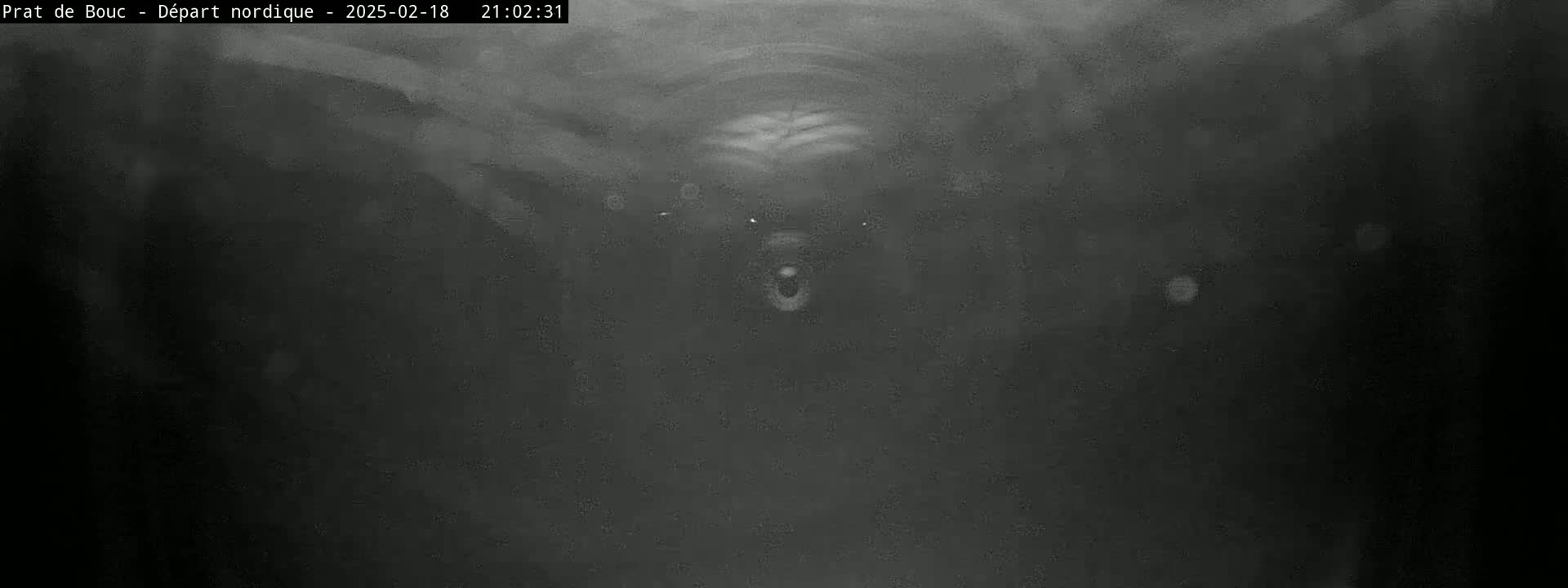 A dark, blurry image shows a tunnel-like structure at night.