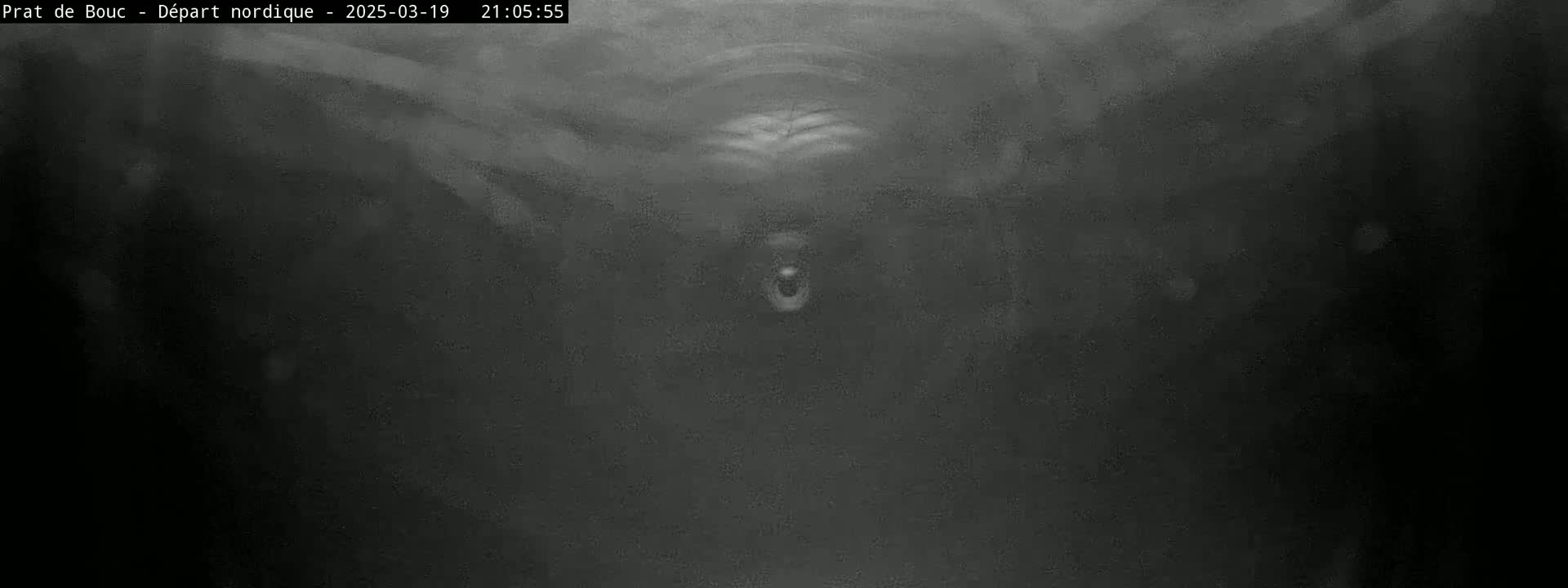 A dark, blurry image shows a faintly visible object in the center, possibly underwater or in heavy fog.