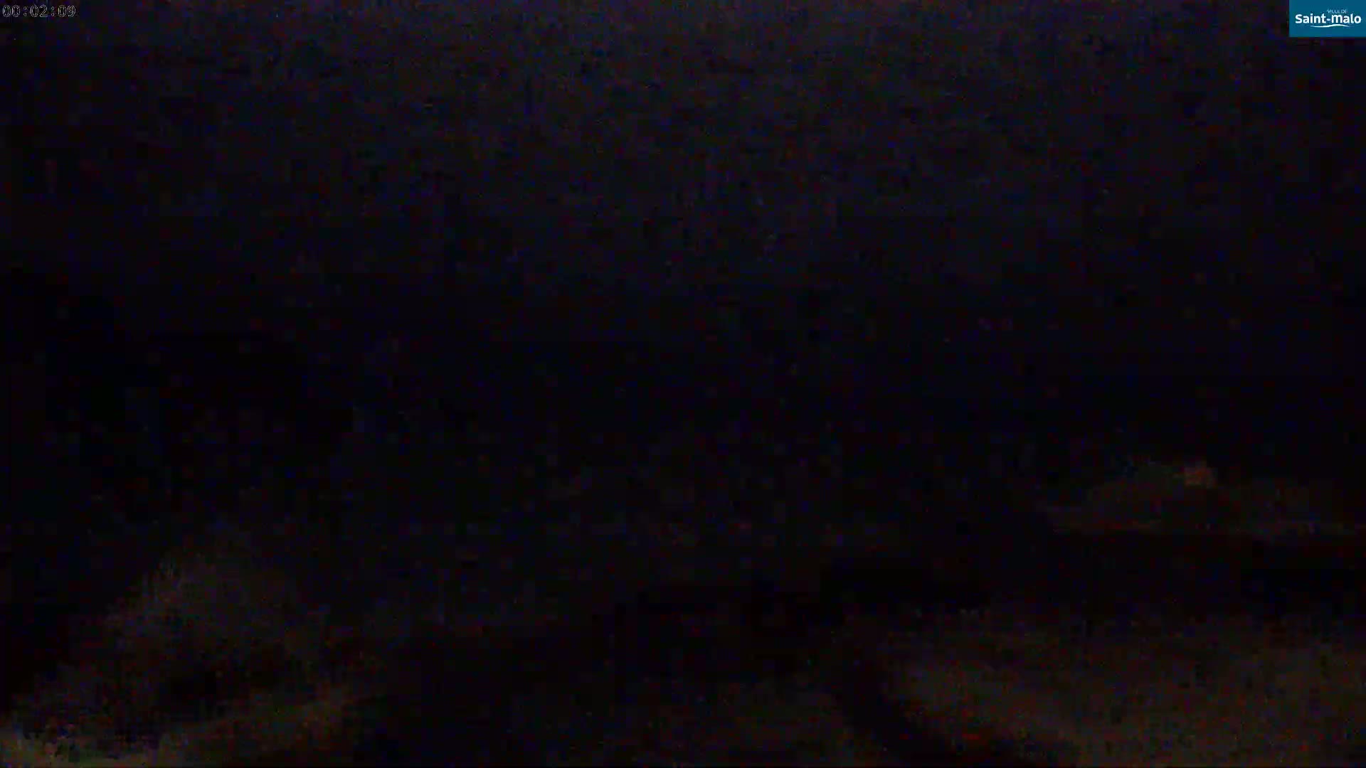 A very dark, nighttime image shows a mostly indistinct ground plane.