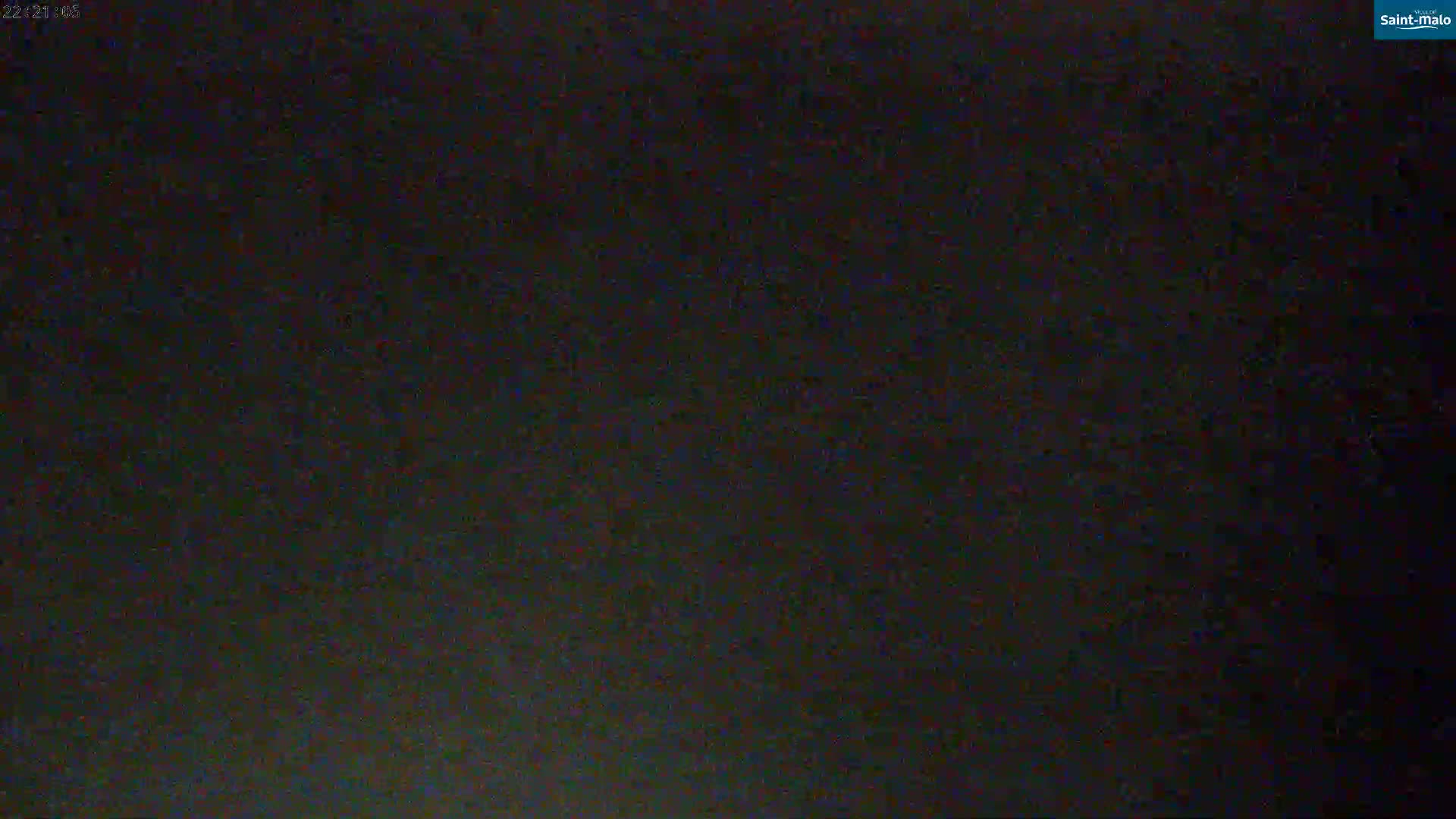 The image shows a dark, grainy, mostly black screen with subtle variations in shade.