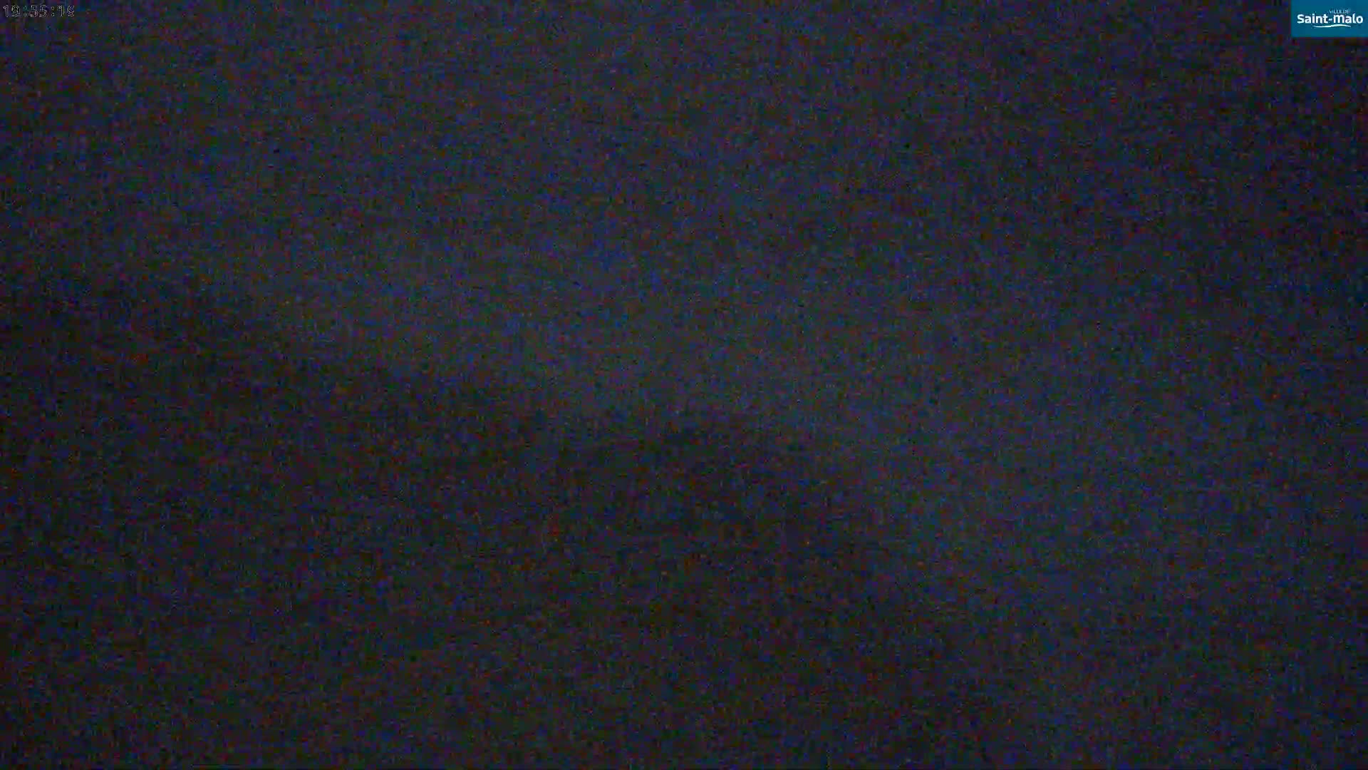 A dark, grainy image shows a mostly dark, possibly nighttime scene.