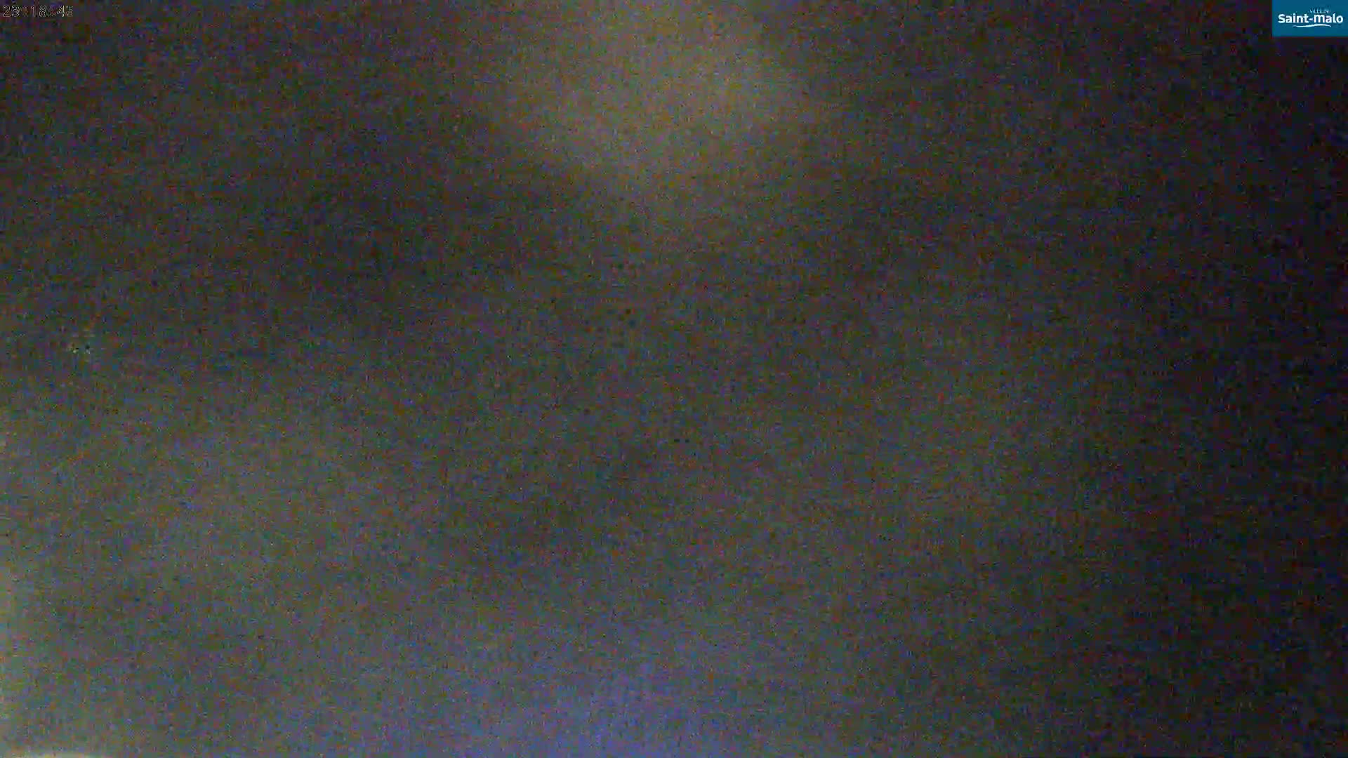 The image shows a dark, blurry view of a night sky.