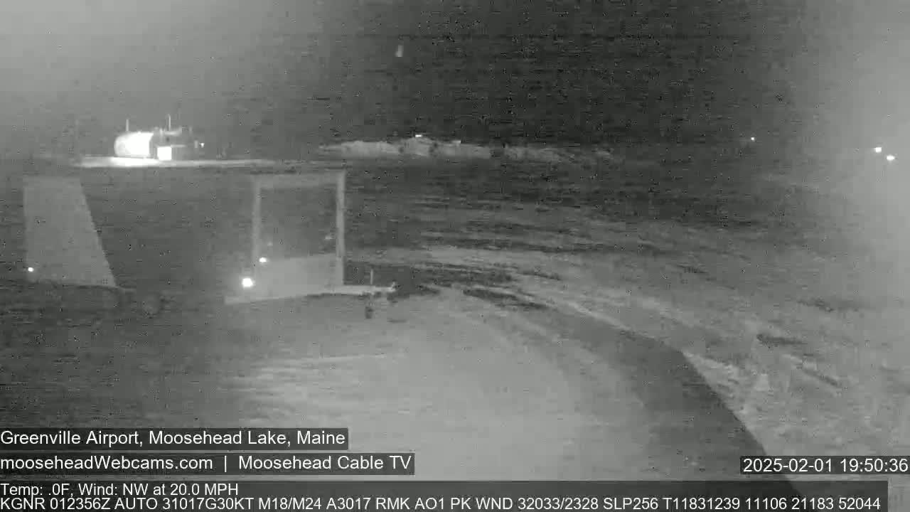 A nighttime, snow-covered airport runway is viewed under a northwest wind of 20 mph and a temperature of 0°F.