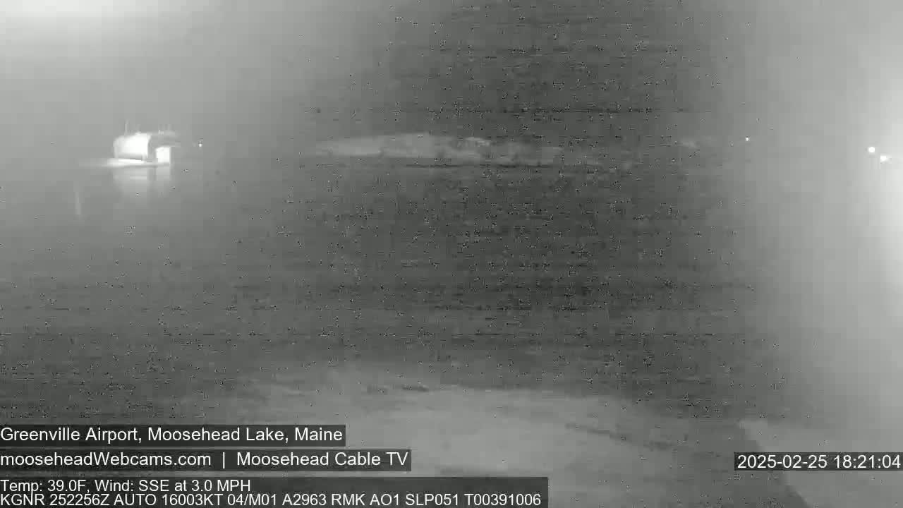 A nighttime, low-visibility view of a body of water with a hazy atmosphere.
