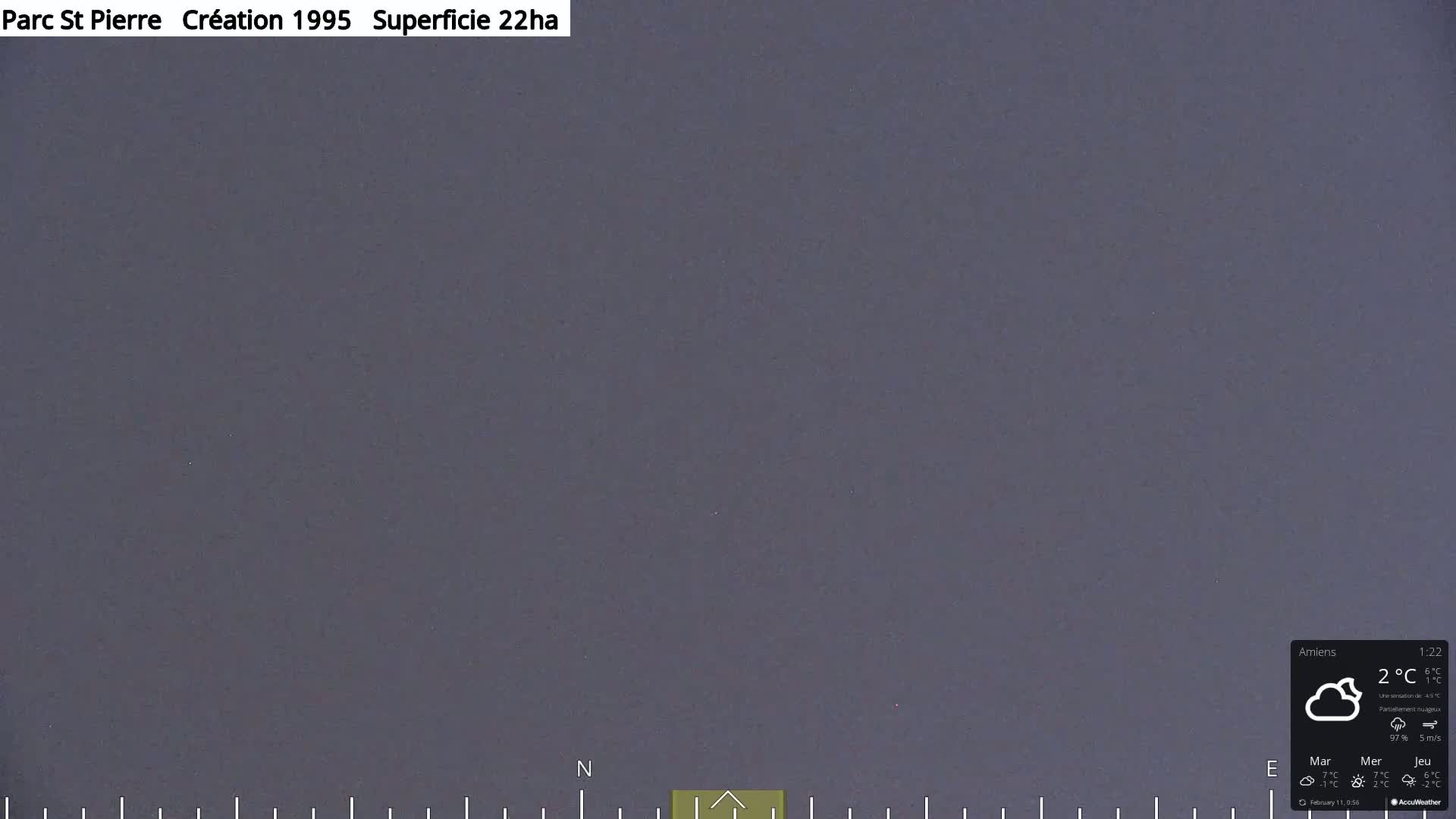 A mostly cloudy, dark gray sky is visible.