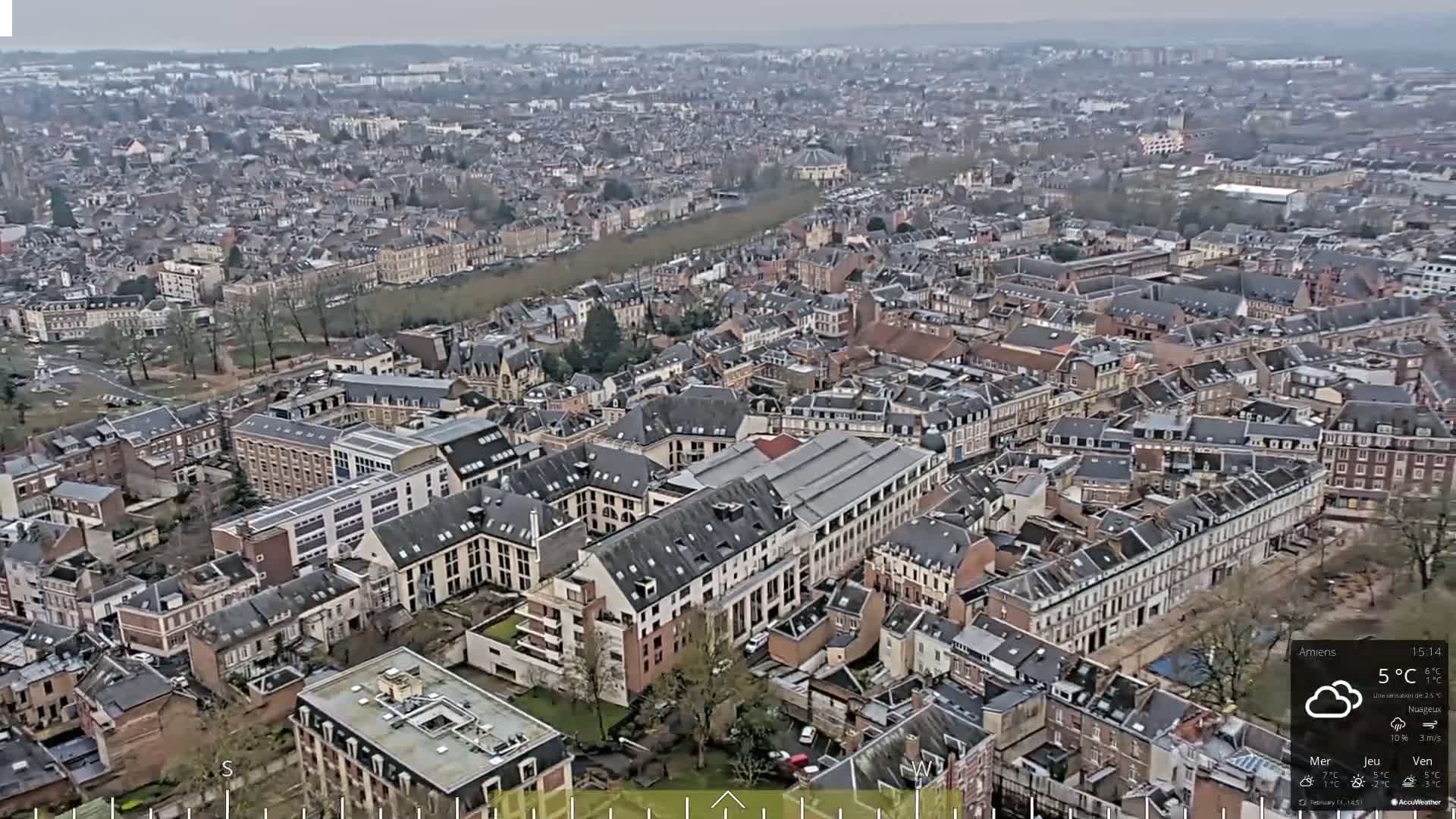 A high-angle, long shot of a densely populated city on an overcast day.