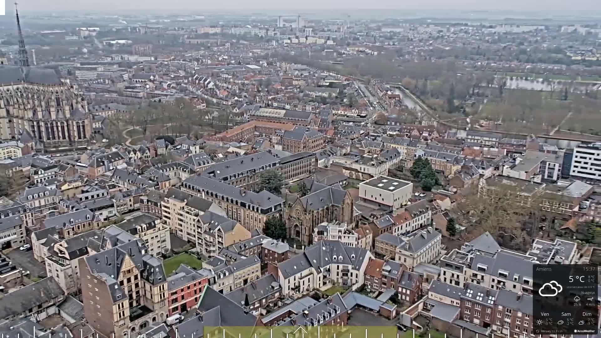 An aerial view shows a densely populated European city on an overcast day.