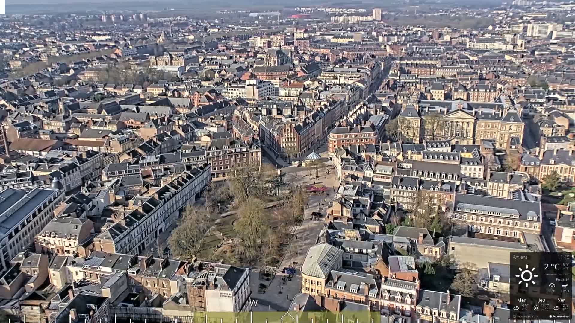 A high-angle, sunny view of a densely populated European city with many closely-spaced buildings.