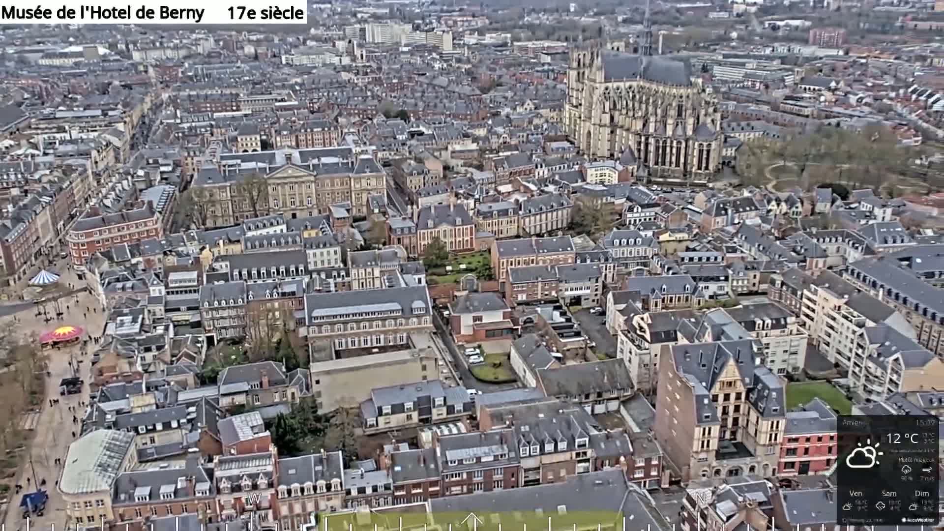 An aerial view of a European city on an overcast day, showing a dense collection of buildings and a large cathedral.