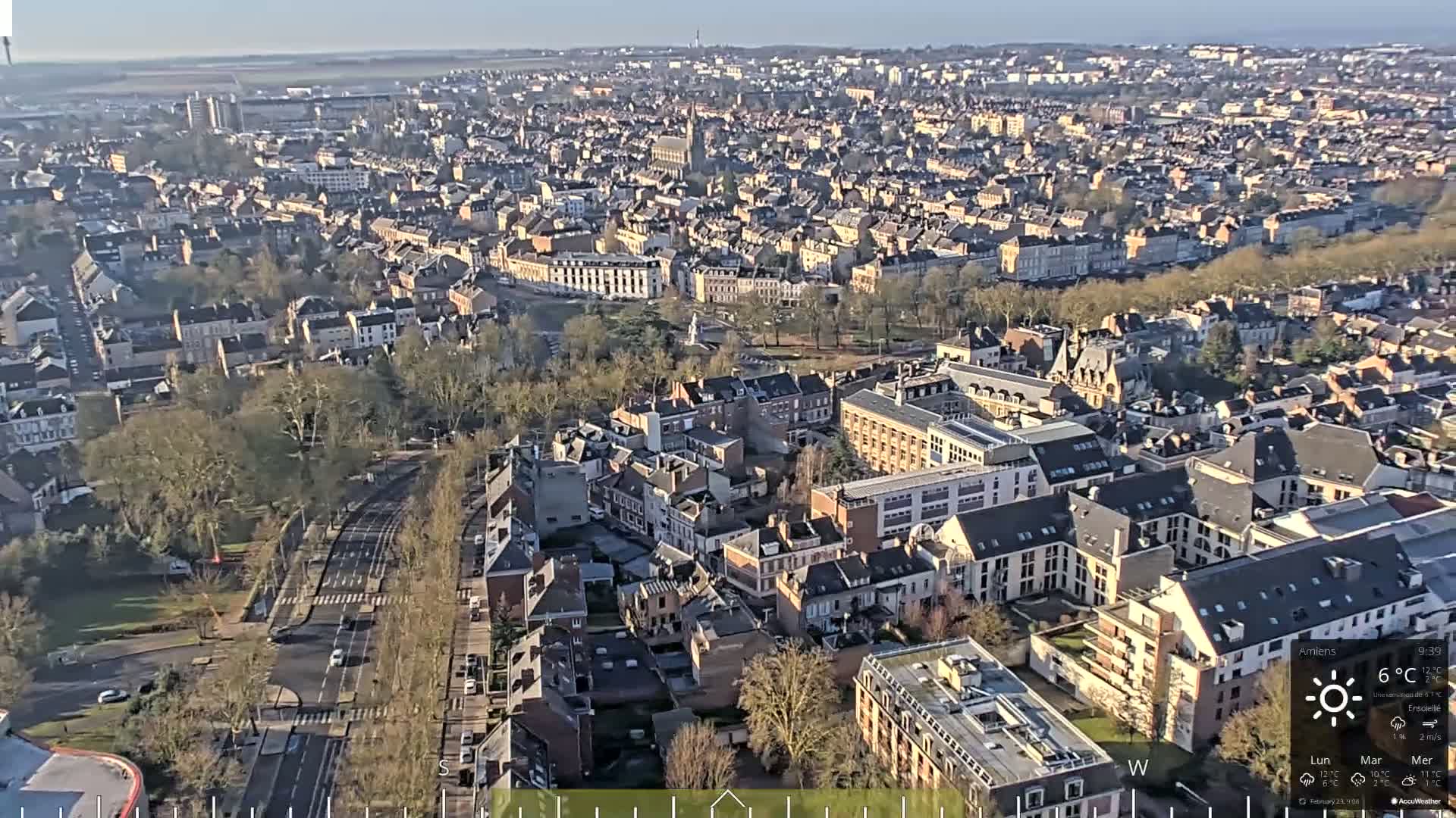 A high-angle, long shot of a densely populated city on a sunny day with clear skies.