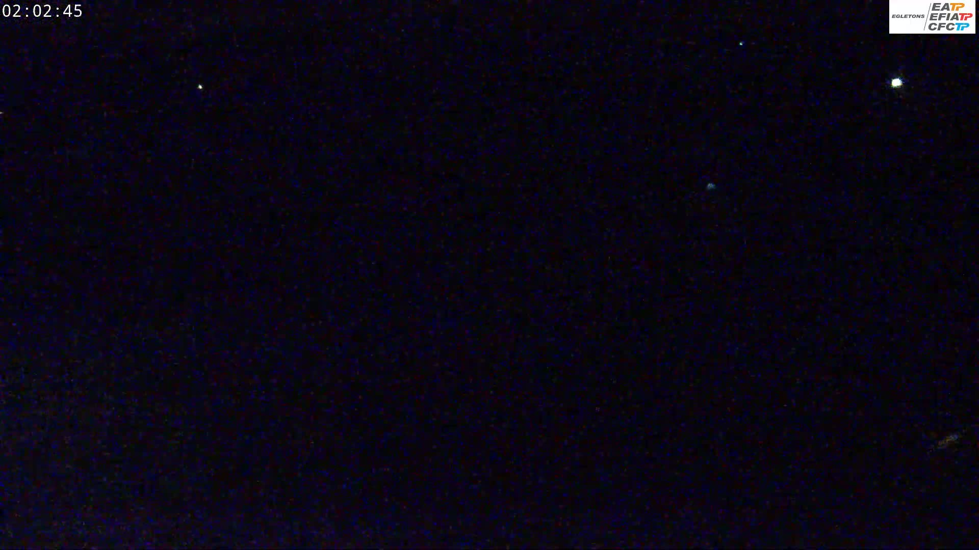 A nighttime image shows a dark sky with several bright stars visible.