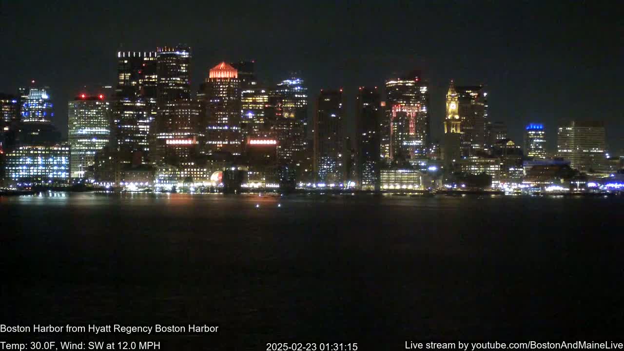 A nighttime view of a brightly lit city skyline across dark water, with a 30°F temperature and a southwest wind at 12 mph.