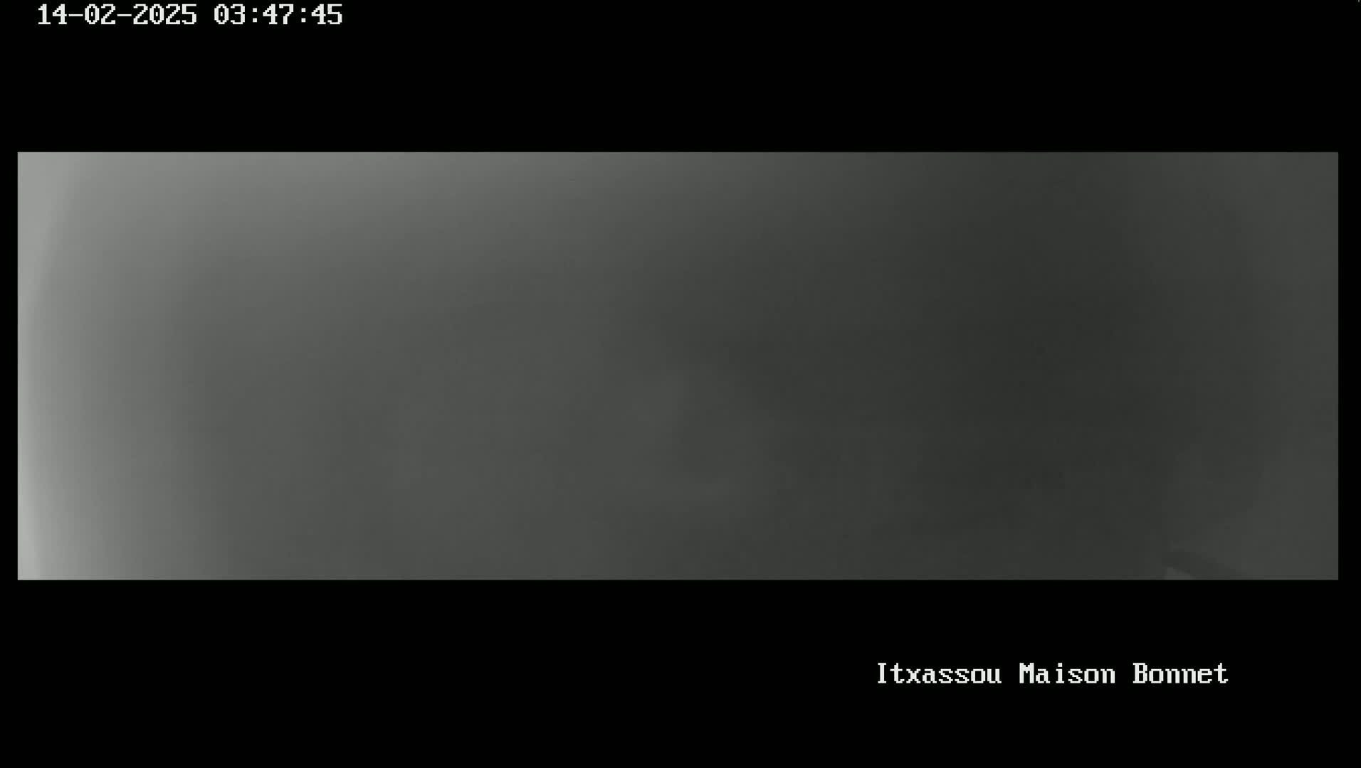 A blurry, dark gray image shows an overcast sky.