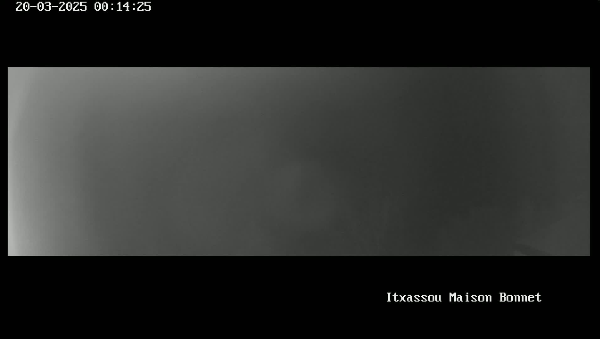 A blurry, dark gray image shows an overcast sky.