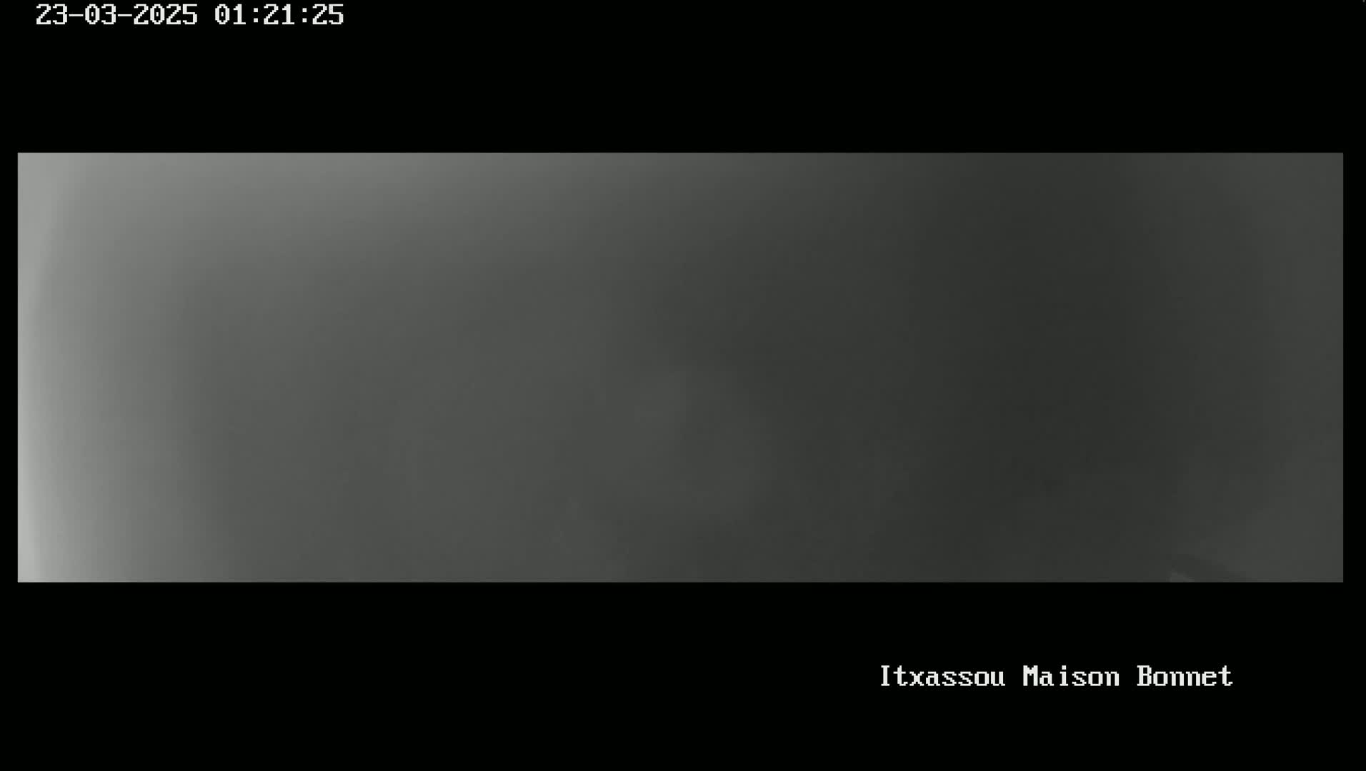 A dark gray, overcast sky is visible.