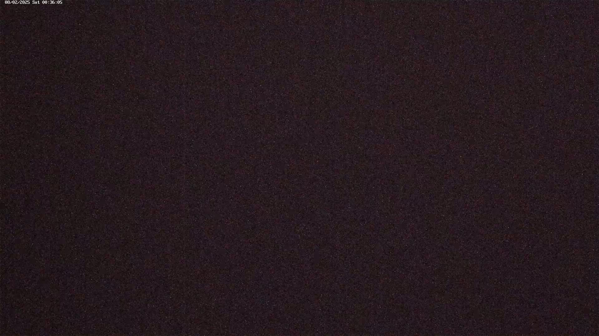 A dark, grainy image, possibly depicting a night sky.