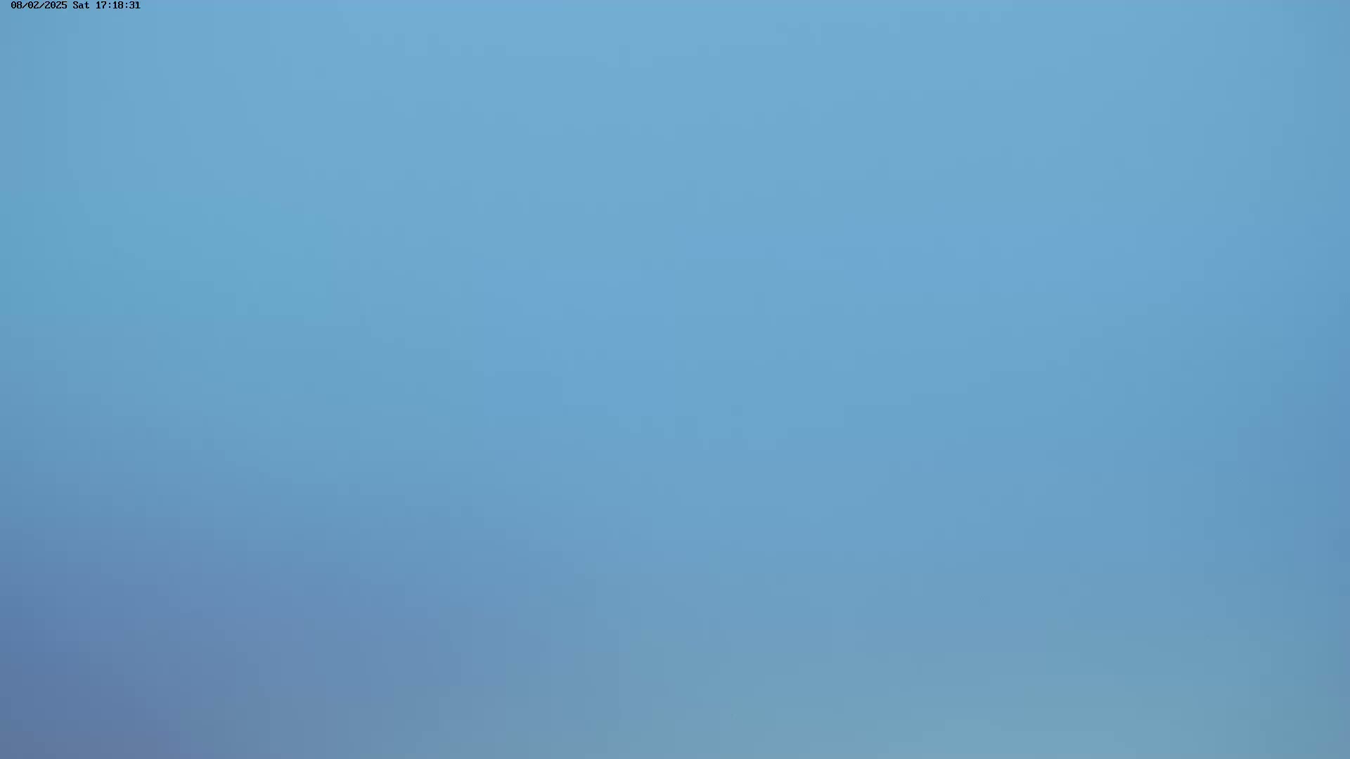 The image shows a clear, light-blue sky.