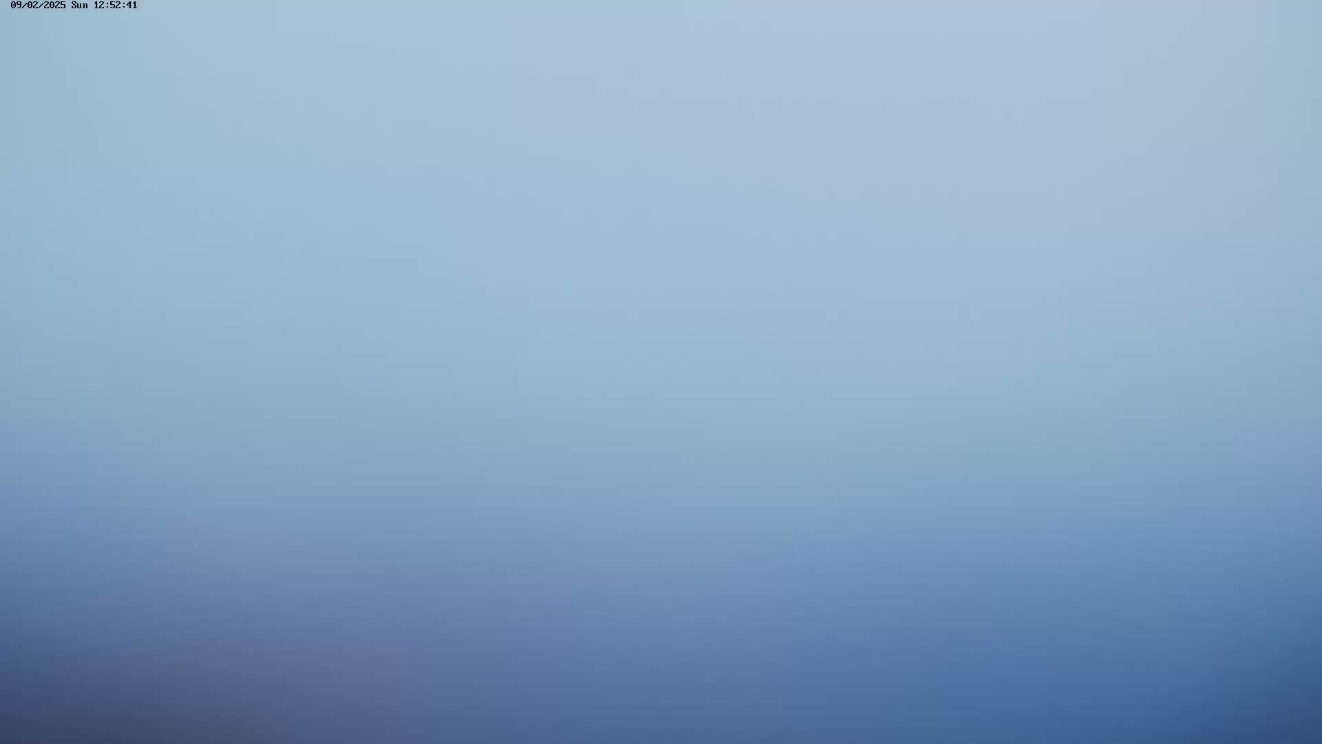 A hazy, light-blue sky is visible.