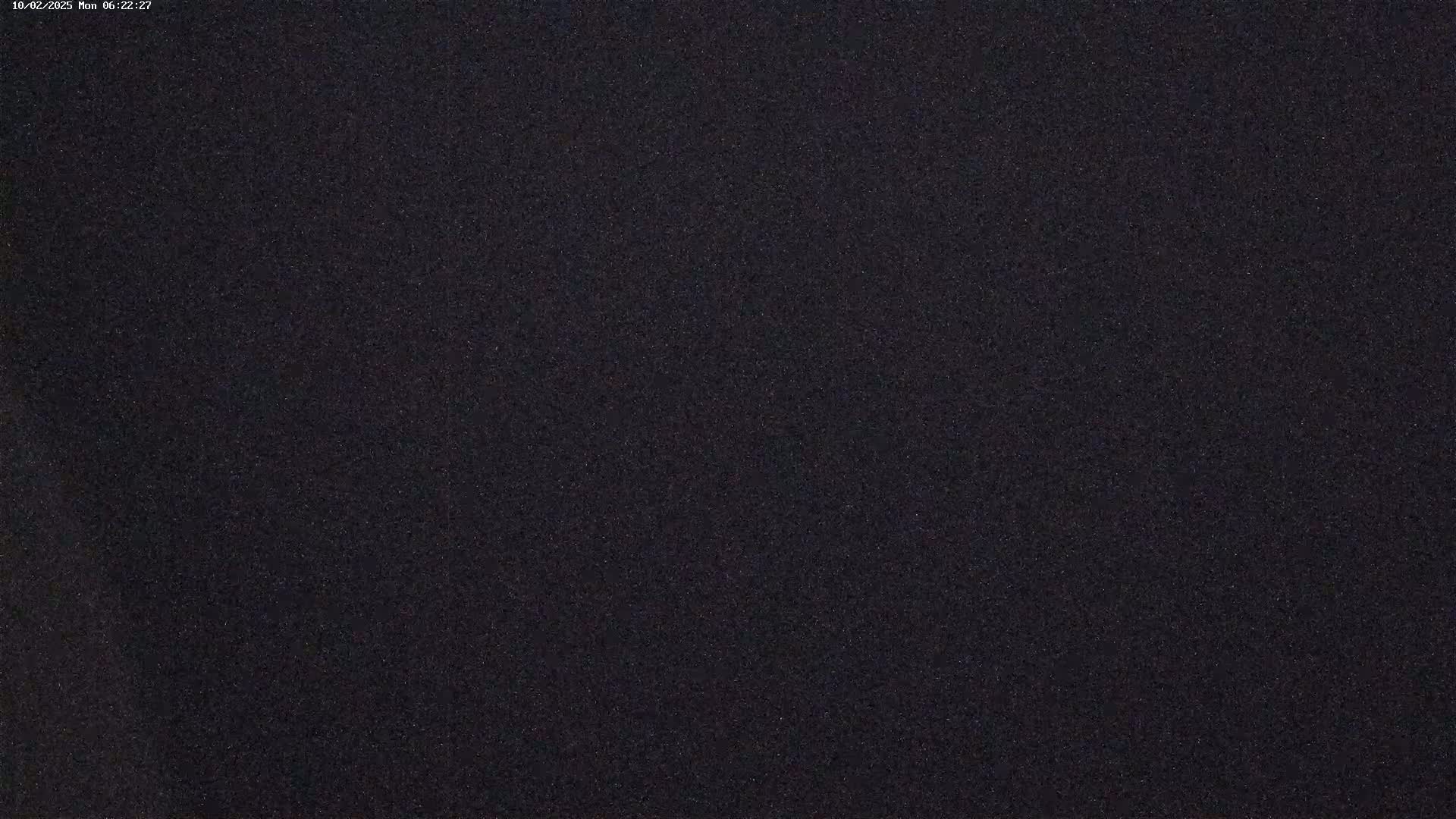 A dark, grainy image shows a mostly uniform black surface.