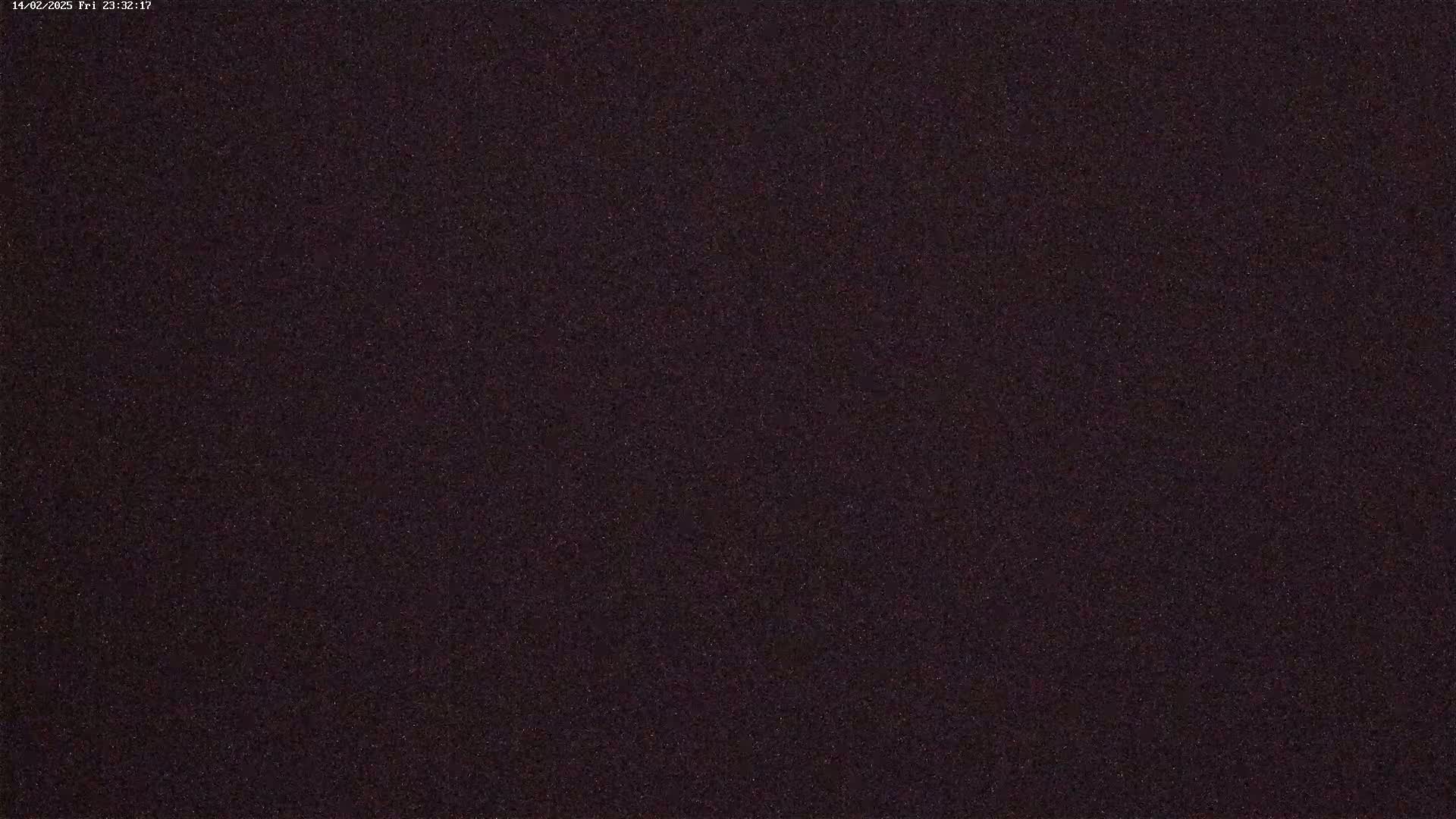 A dark, grainy image, possibly depicting a night sky.
