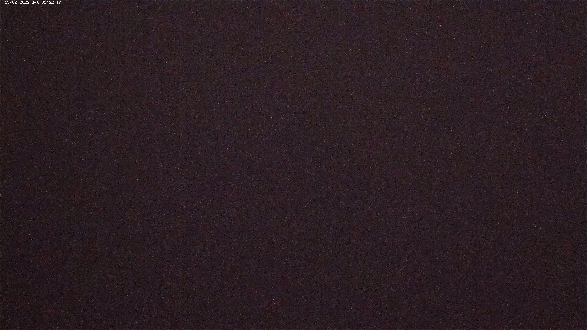 The image shows a dark, grainy texture, possibly a dark-colored surface or a heavily obscured night scene.