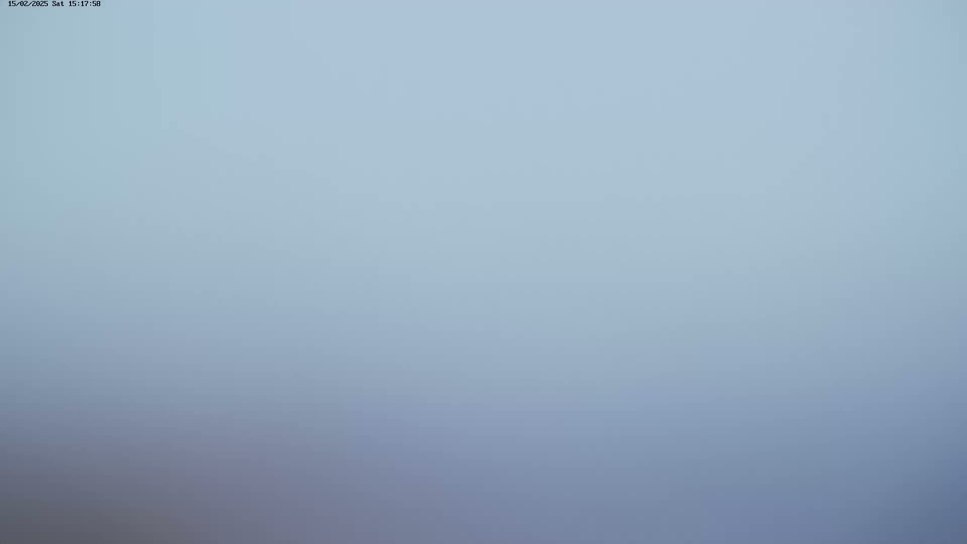 A pale blue, hazy sky is visible.