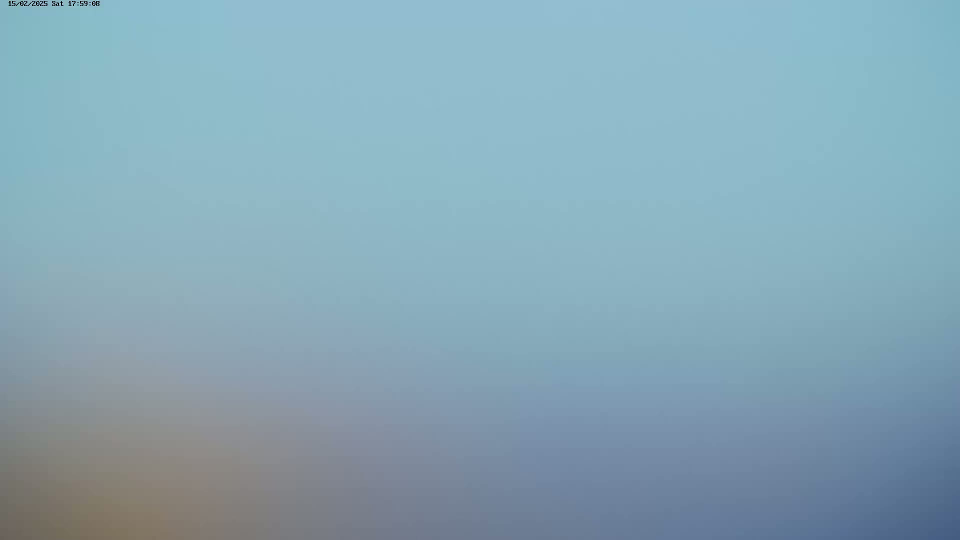 A hazy, light-blue sky is visible.