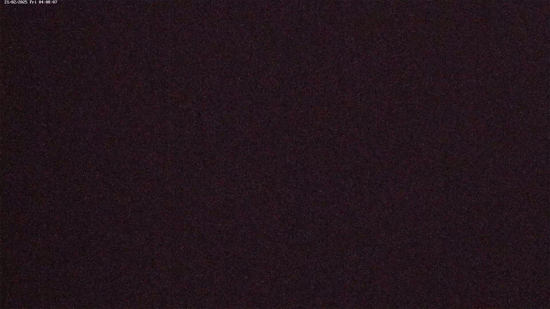The image shows a dark, uniformly textured surface at night.