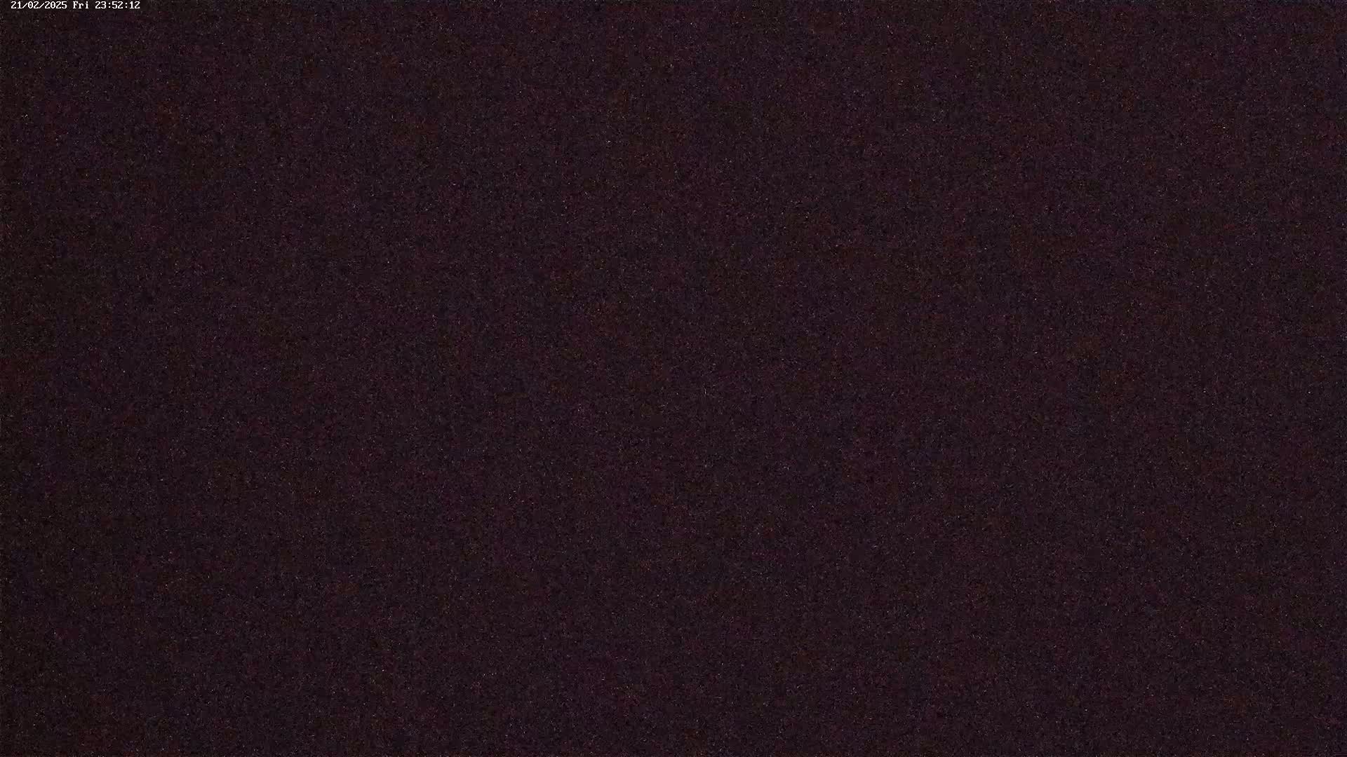 A dark, grainy image shows a night sky.