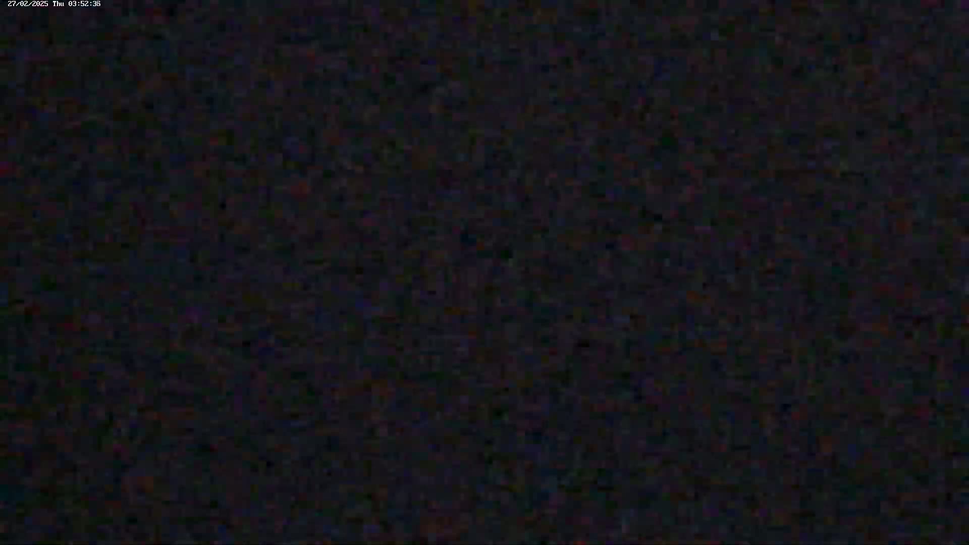 The image is a completely dark, grainy screen.