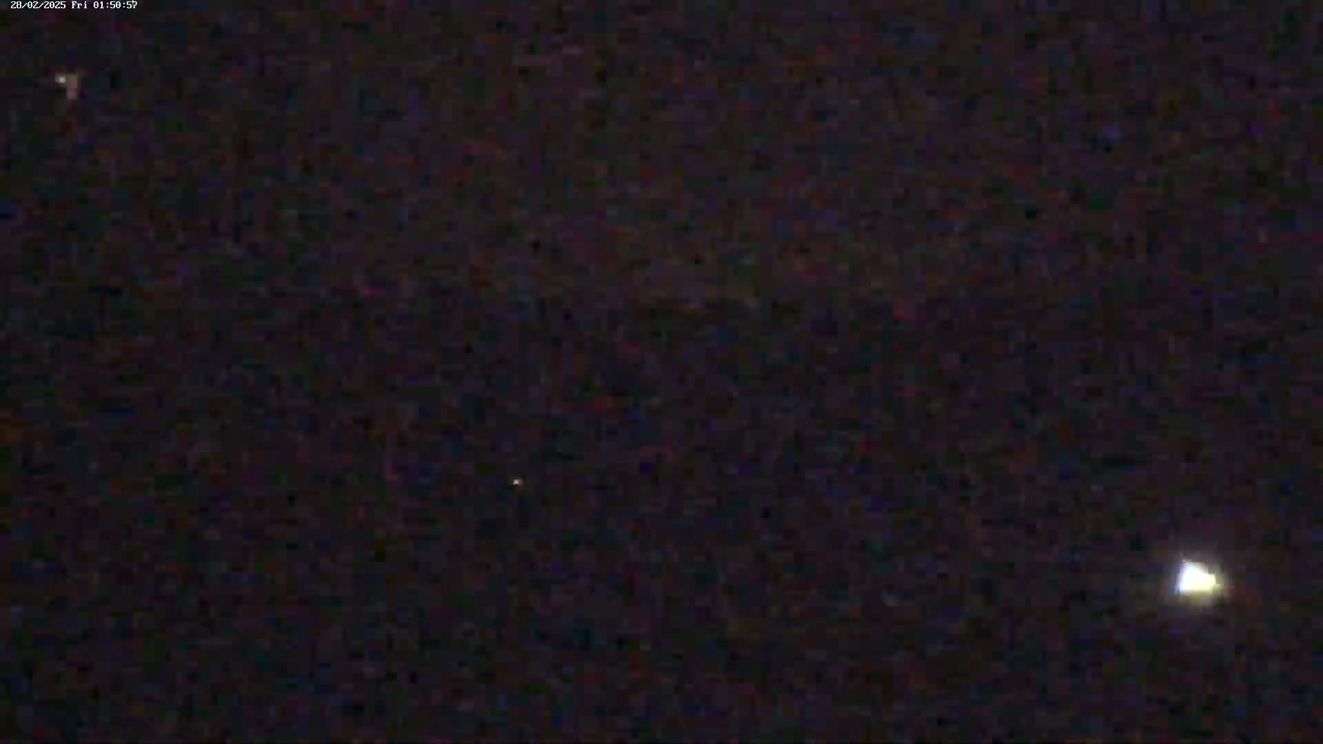 A night-time image shows a dark sky with three faint, distant lights.