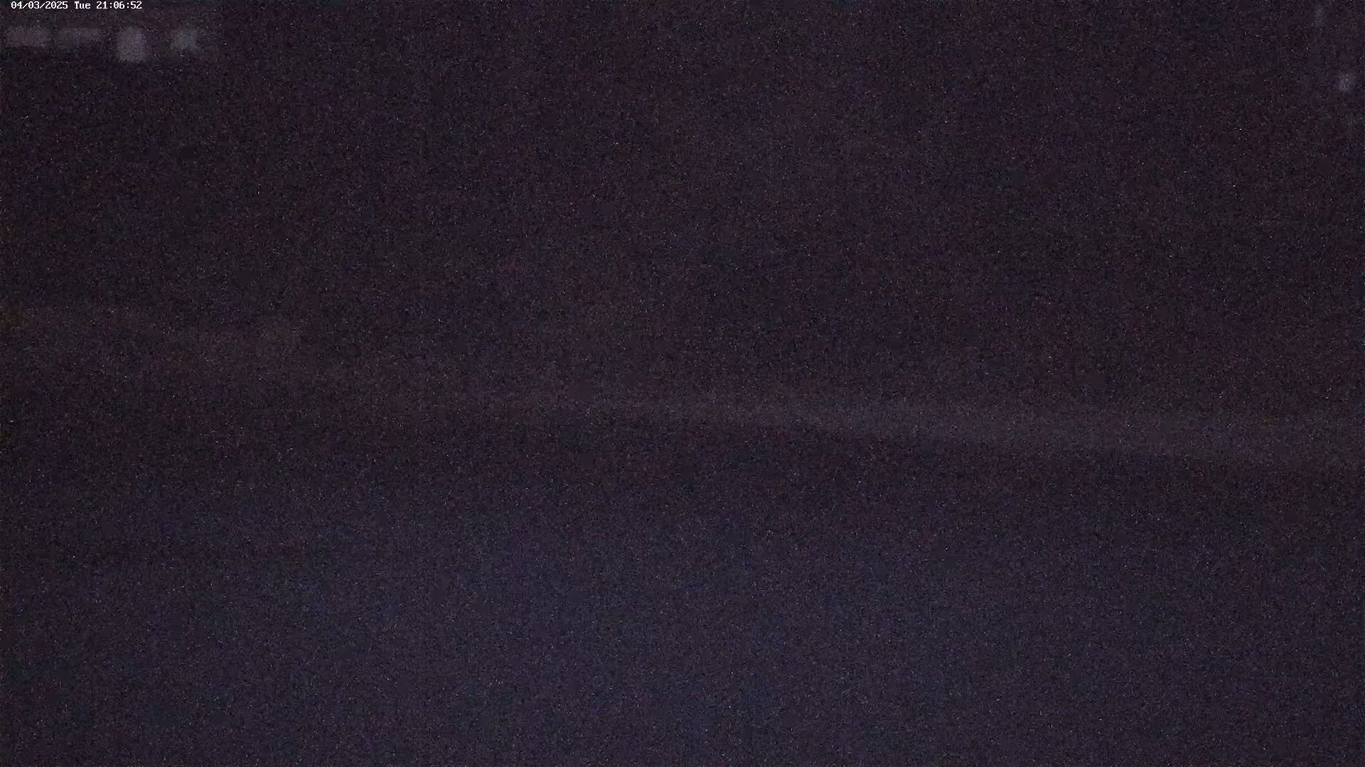 A dark, grainy image shows a nighttime scene.