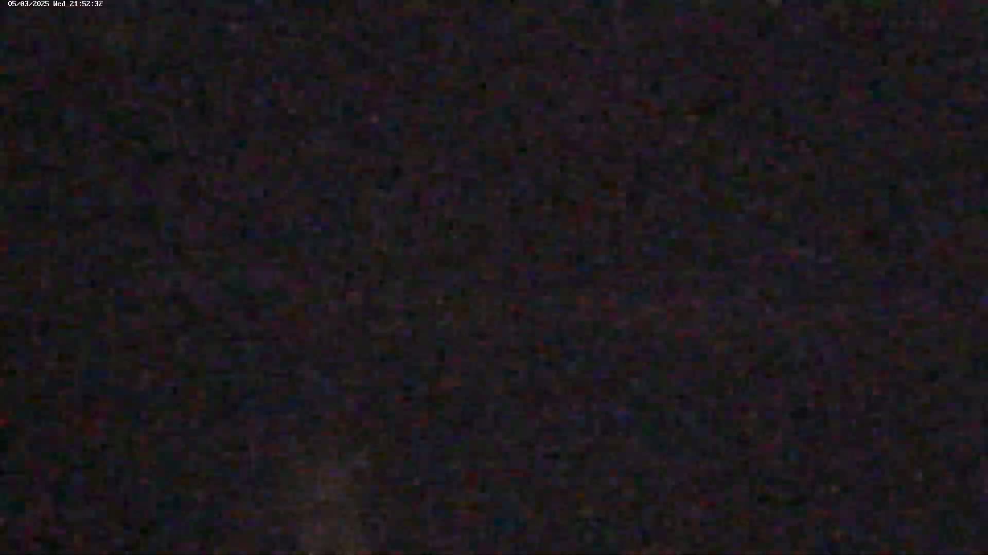 A blurry, dark image shows a mostly black area with subtle variations in shading.