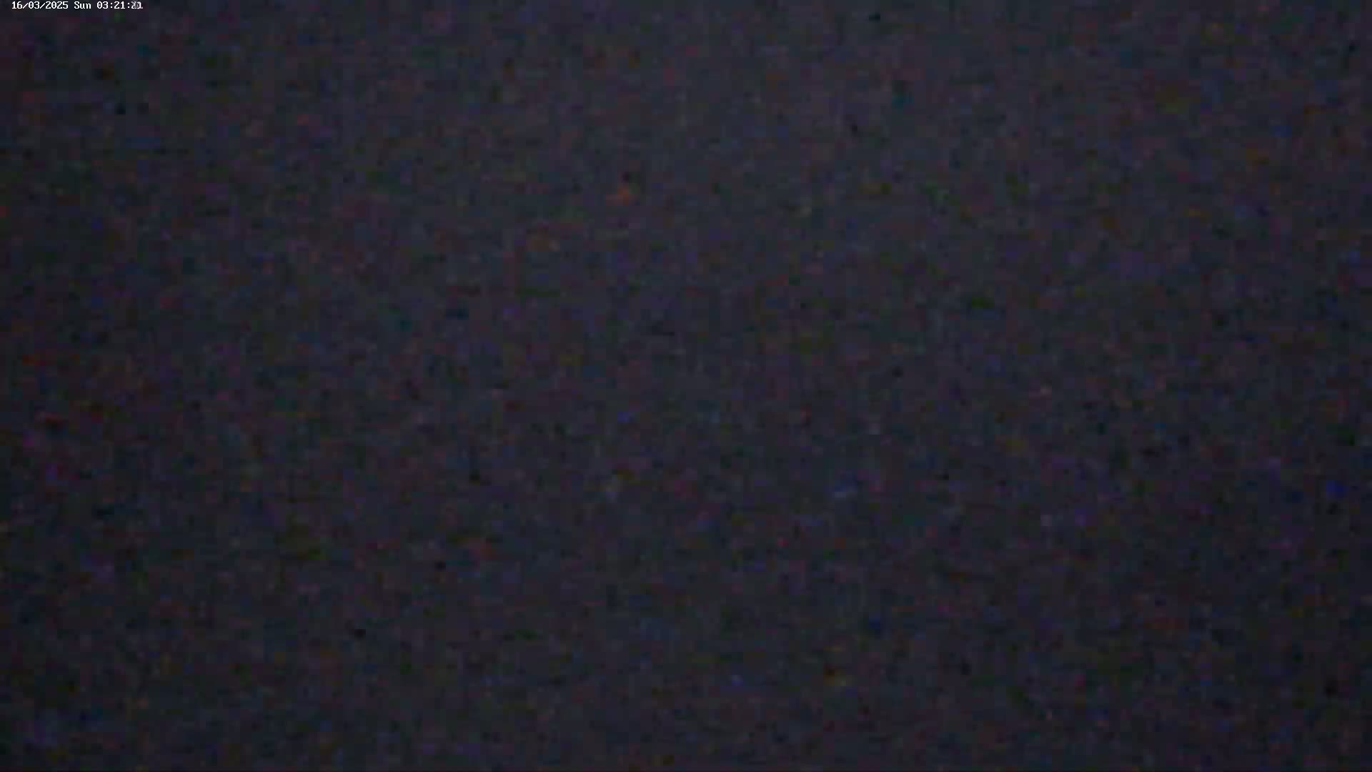 The image shows a dark, grainy, and blurry view, possibly at night.