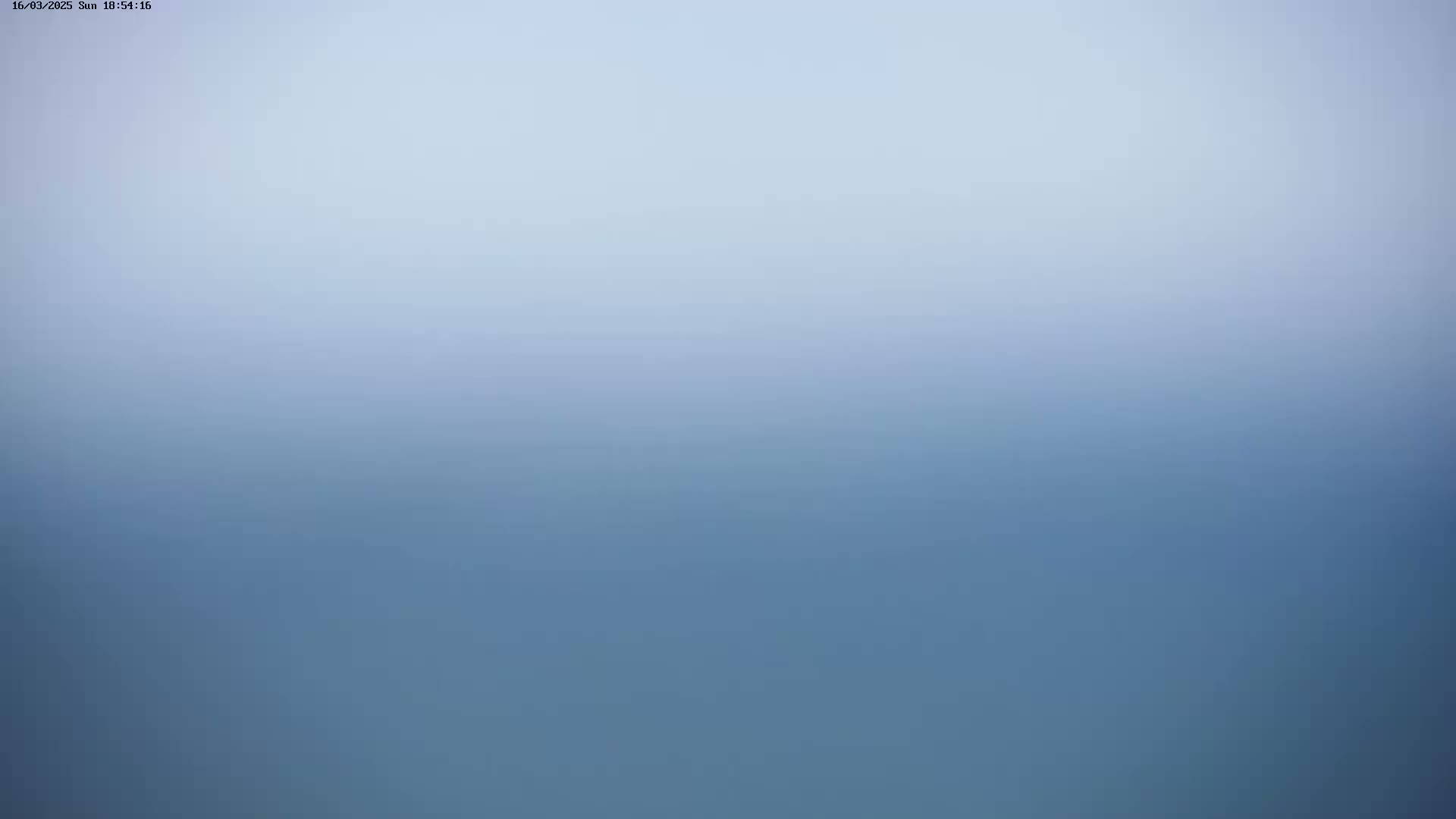 A blurry image shows a hazy, light-blue sky gradually transitioning to a darker blue at the bottom.