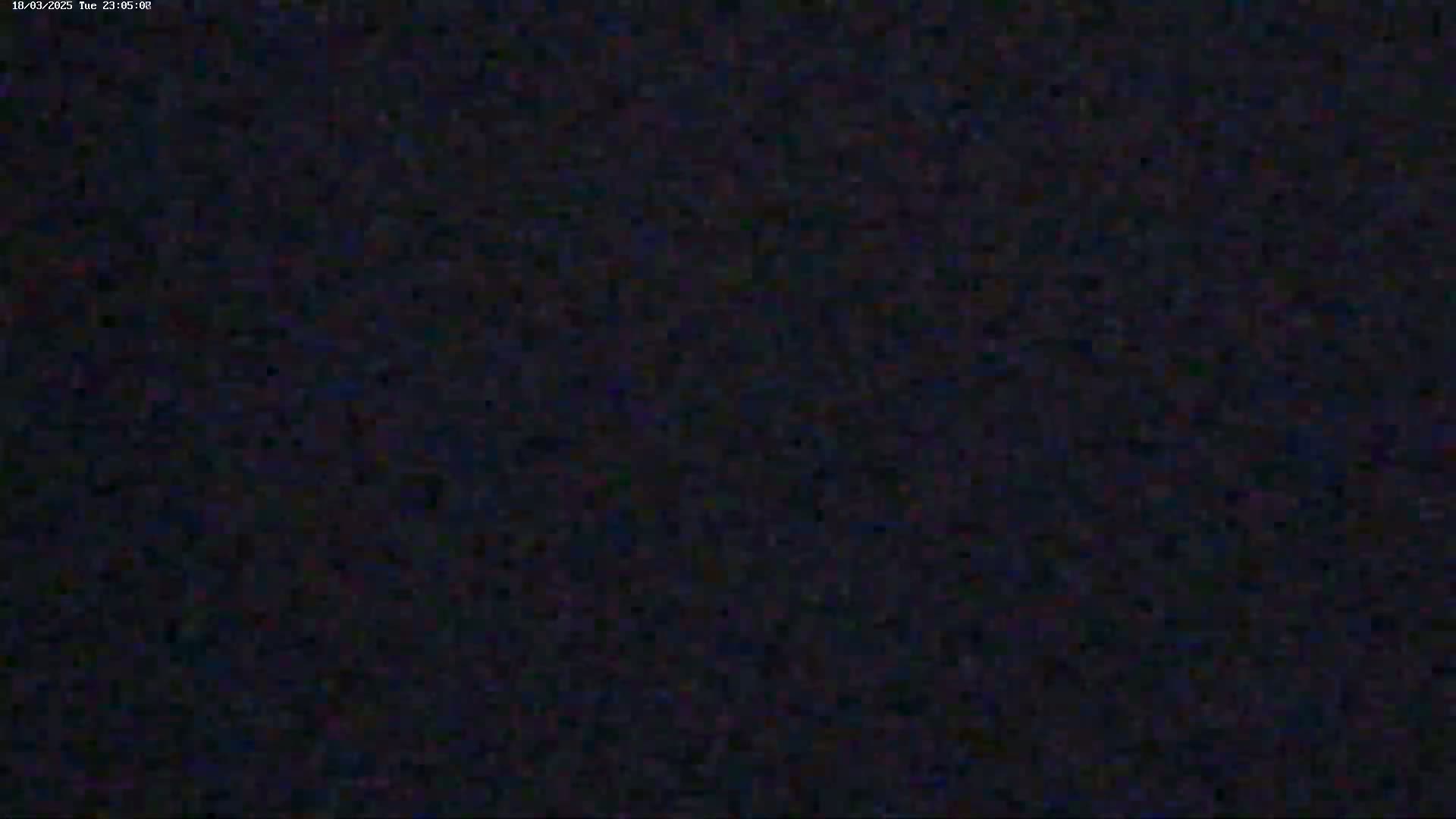 The image shows a dark, grainy, mostly black screen.