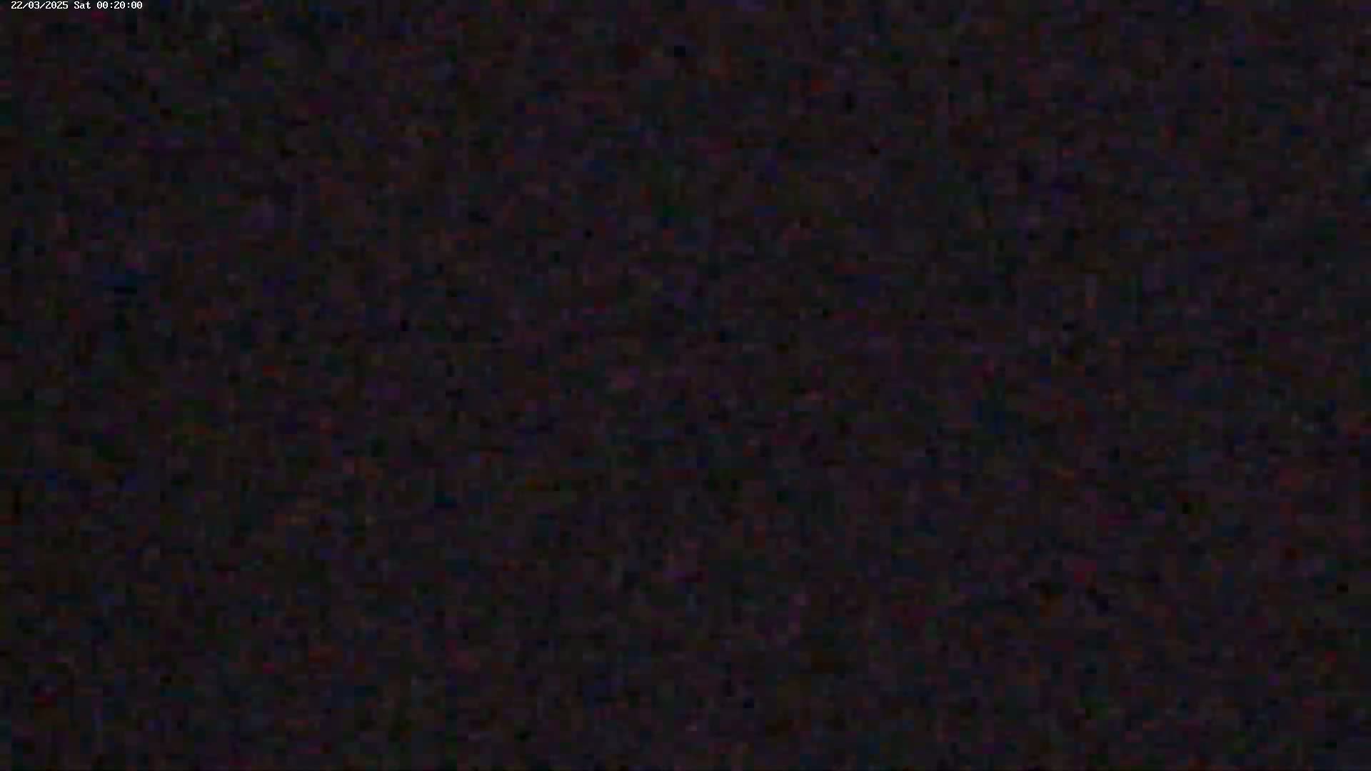 The image shows a dark, grainy, and indistinct view, possibly at night.