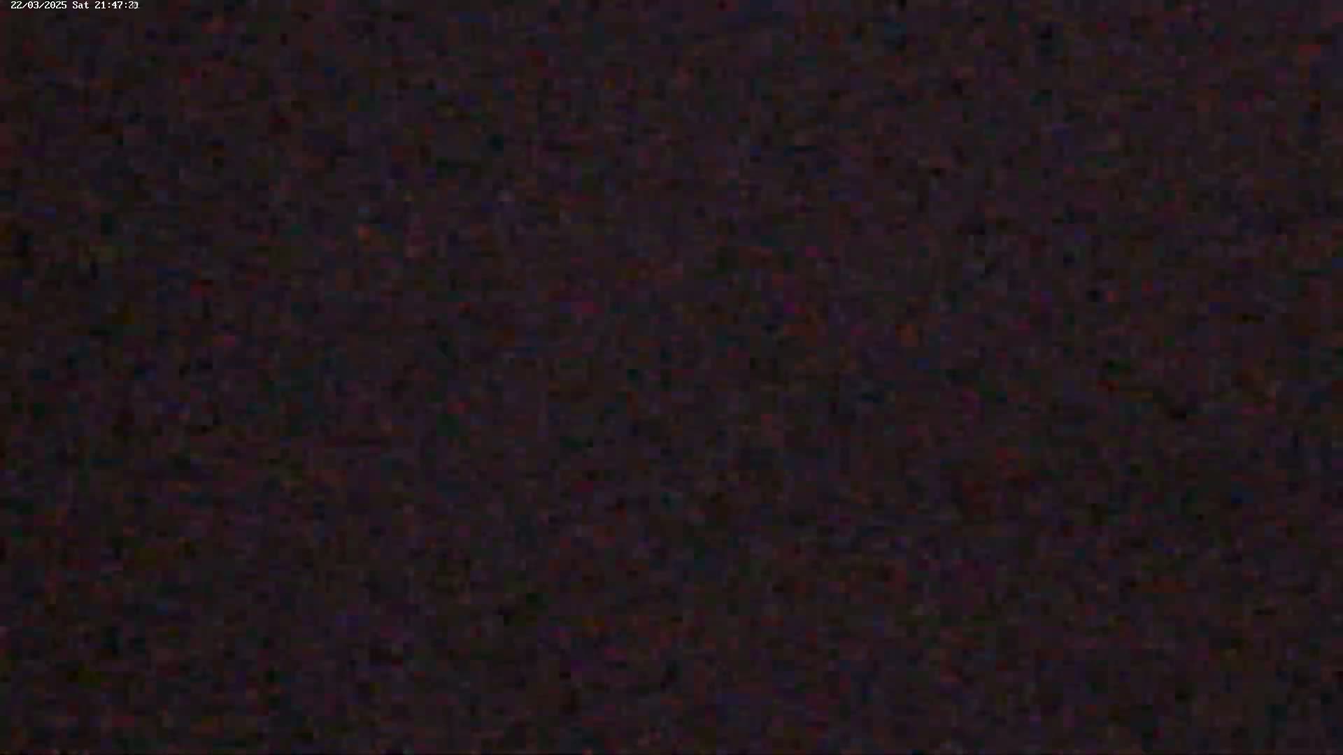 The image shows a dark, grainy, and blurry view, possibly of a night scene.