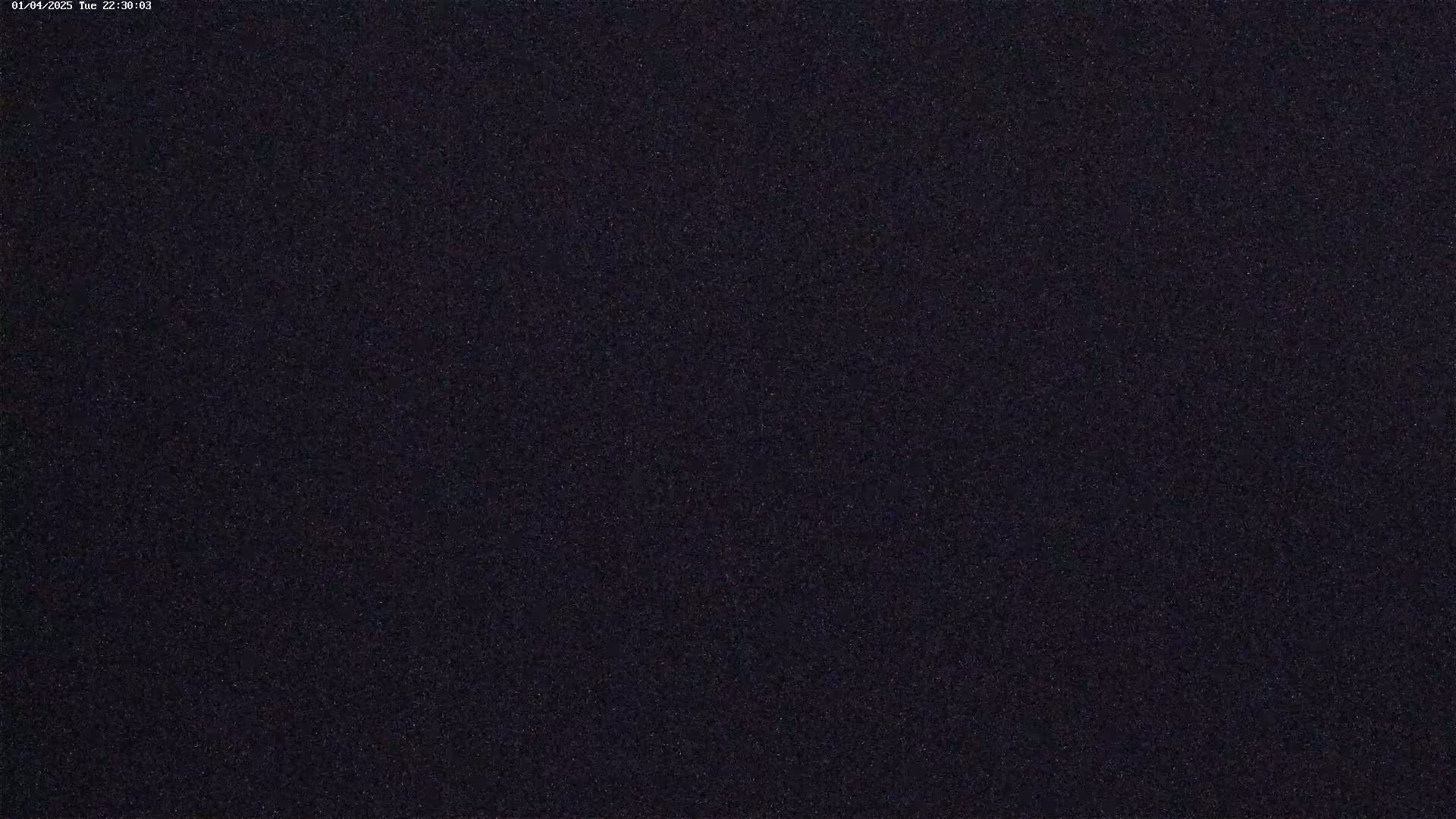 A dark, grainy image shows a night sky filled with numerous faint stars.