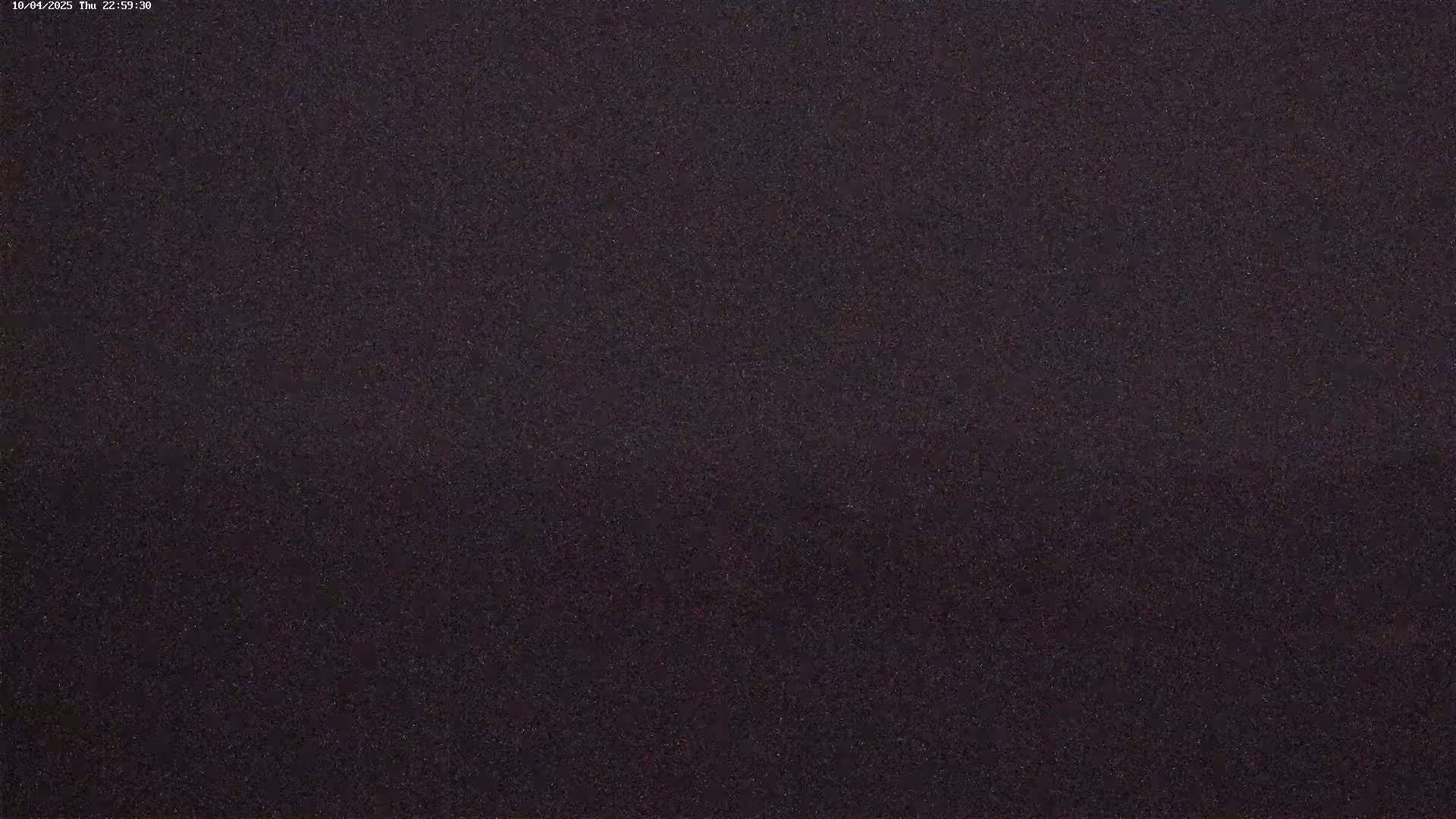 The image shows a dark, uniformly textured surface at night.