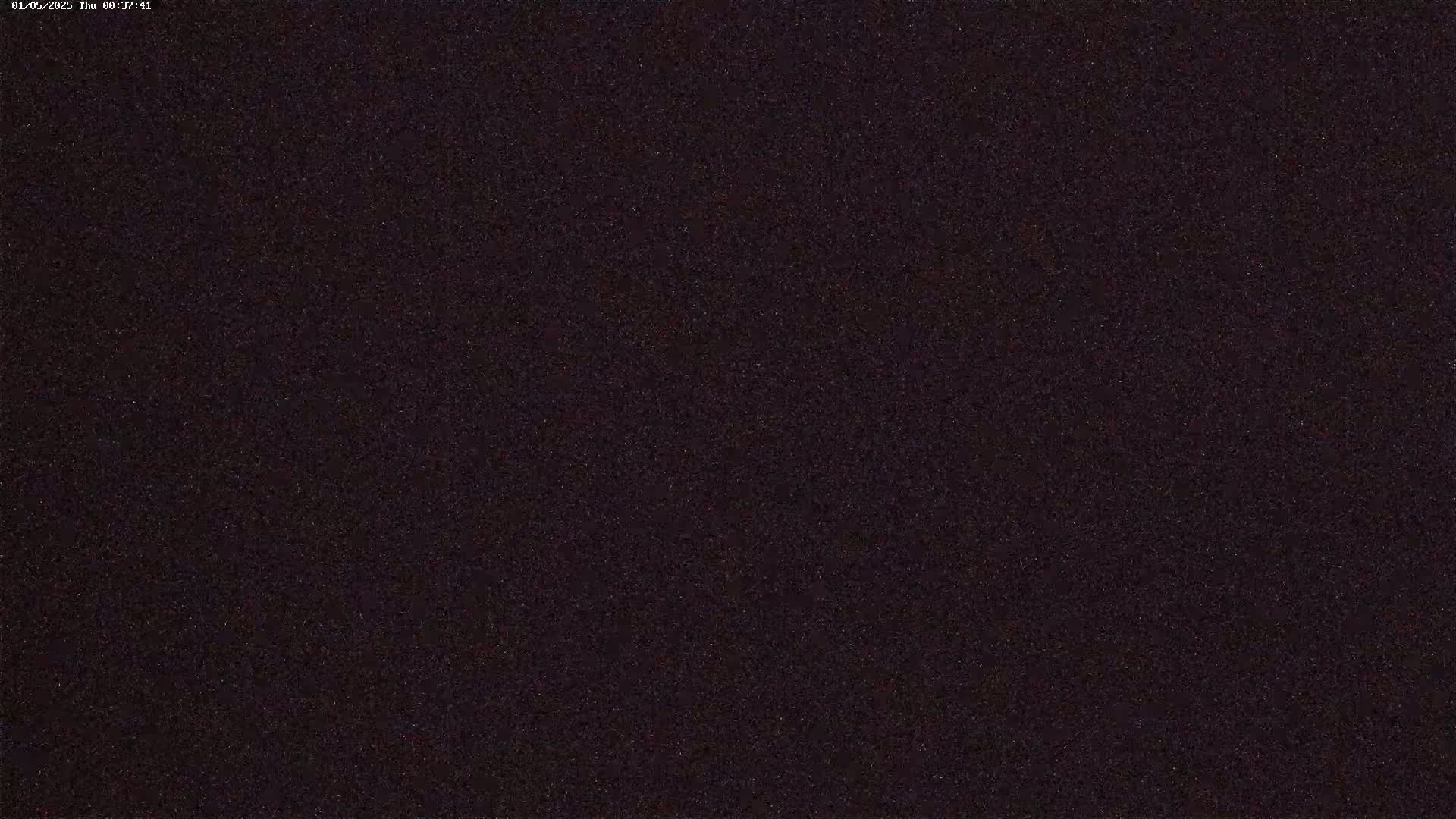 The image shows a dark, grainy texture that appears to be a nighttime sky full of stars.