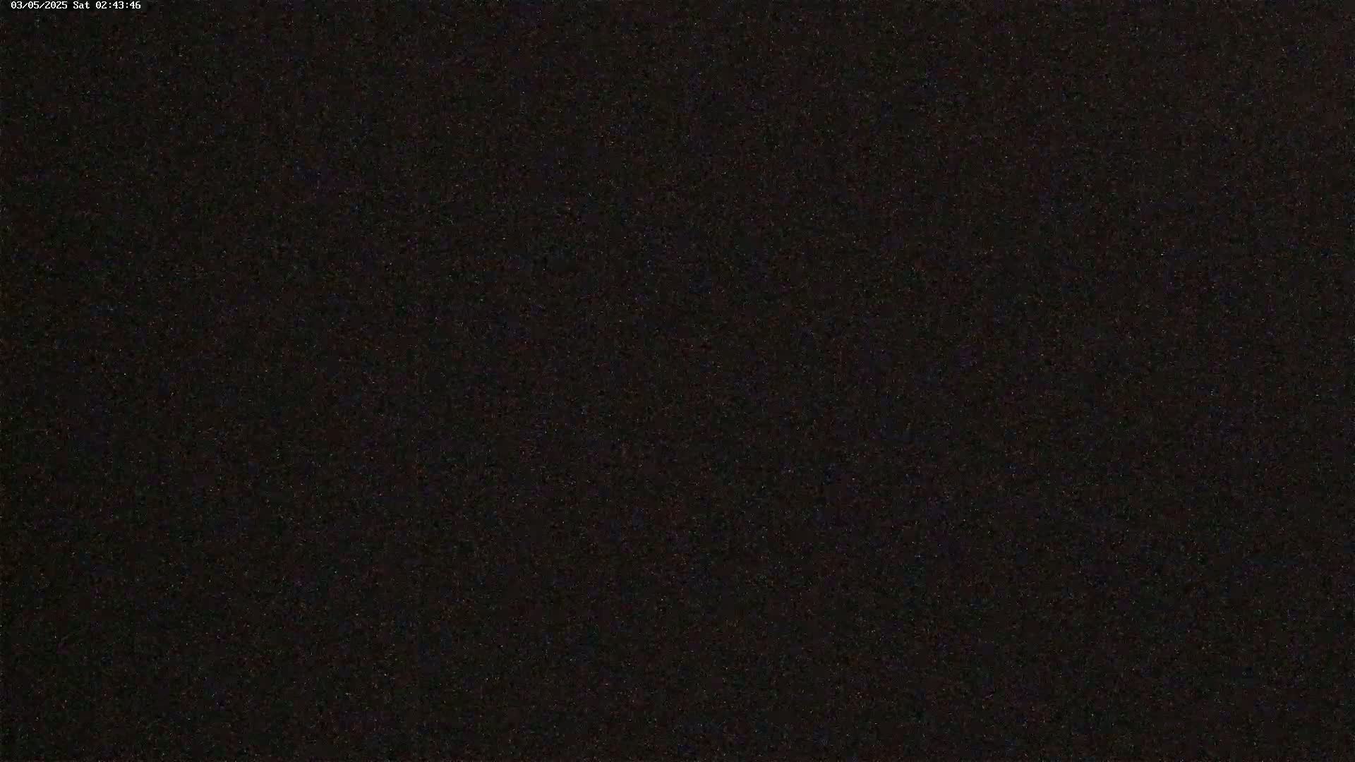 The image shows a completely dark, grainy field of view.