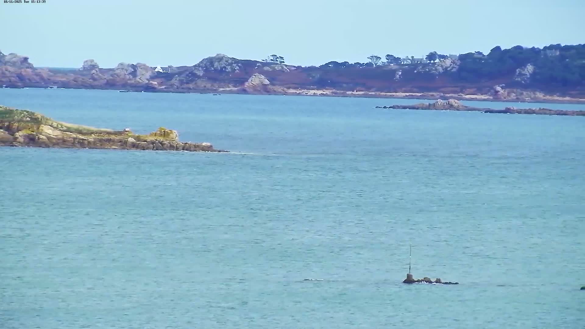 A dark, nighttime scene shows a distant horizon with a few faint lights, and a mostly dark foreground.