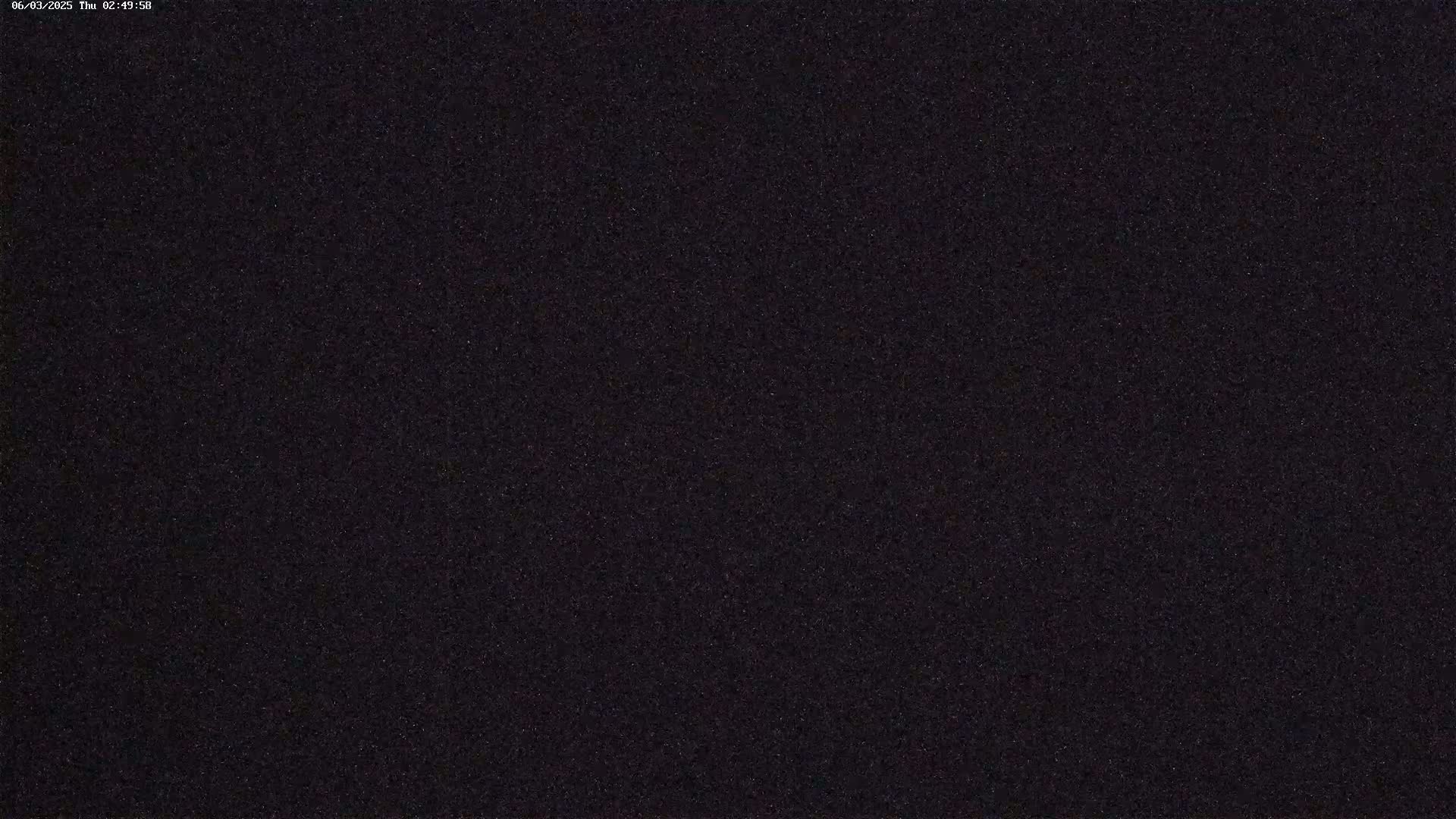 The image shows a dark, uniformly textured surface at night.