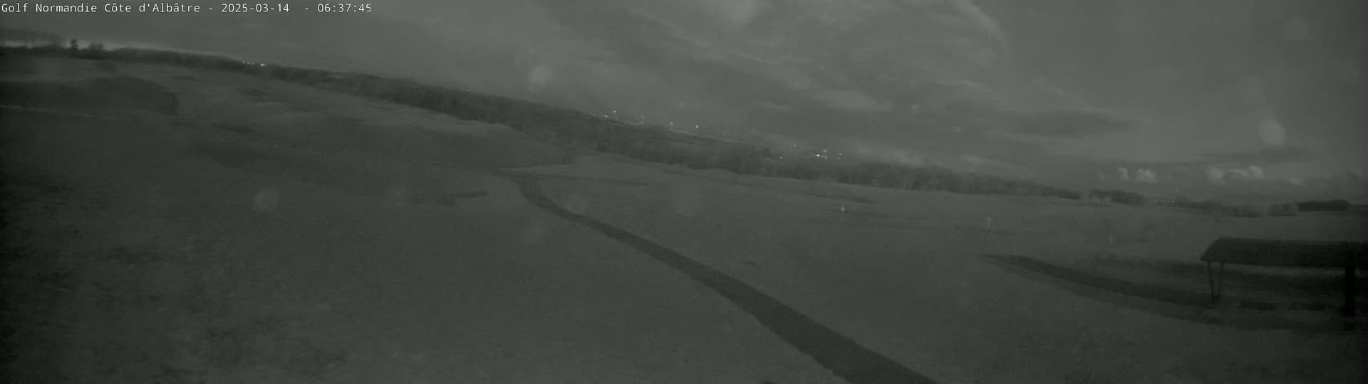A snow-covered landscape is visible under a dark, cloudy sky.